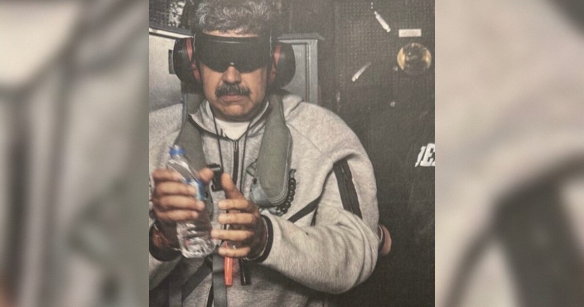 Person wearing protective eyewear and headphones holds a water bottle while engaged in a specialized activity, showcasing safety measures in a controlled environment.