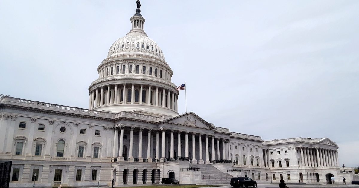 United States Capitol building showcasing its iconic dome and architectural details under a cloudy sky.