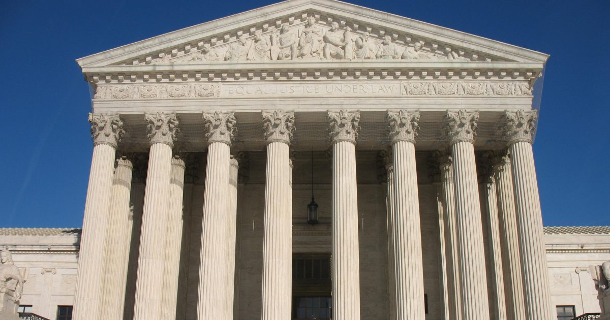 The United States Supreme Court building features classical architecture with prominent columns and a frieze that reads "Equal Justice Under Law."