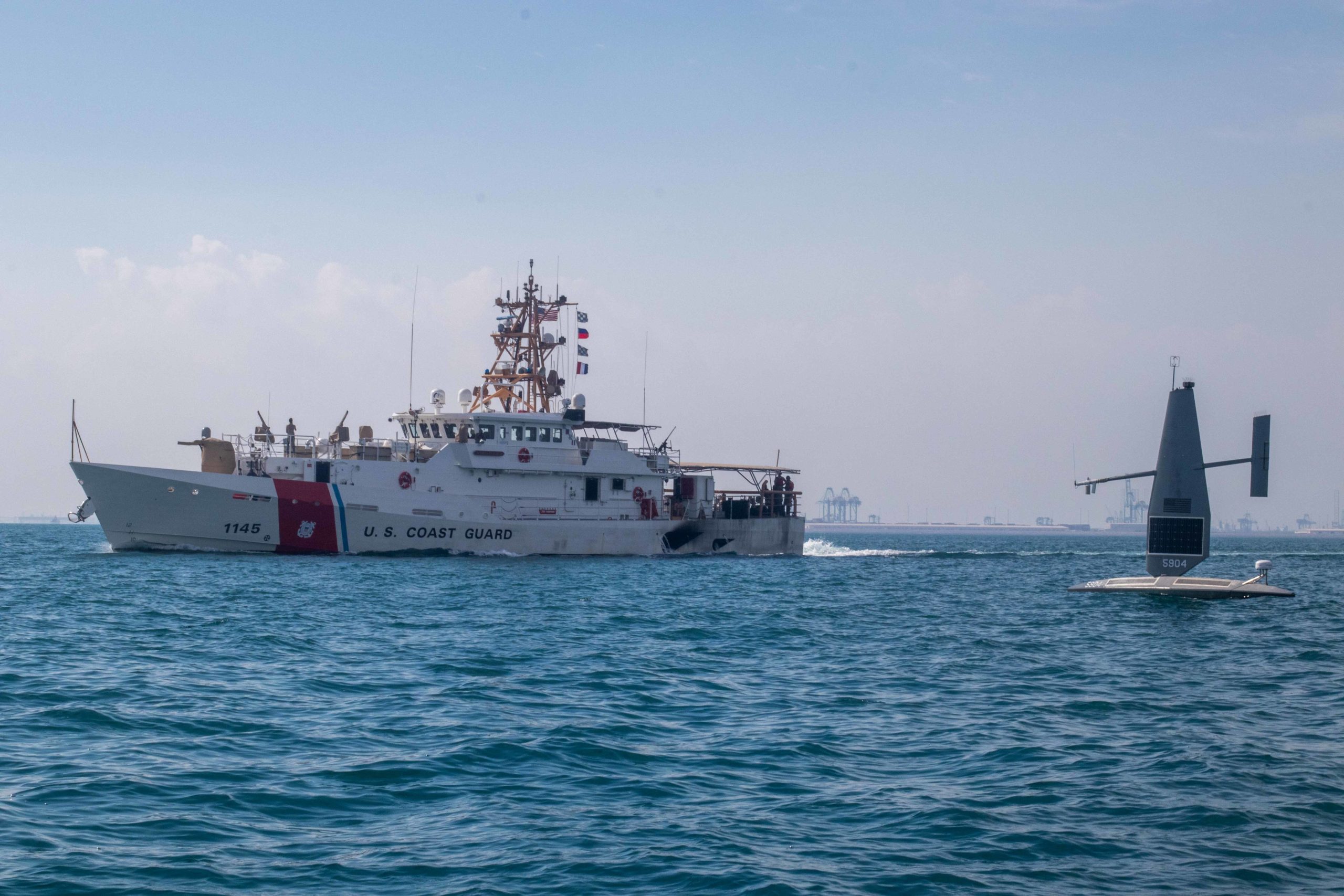 221129-A-RY768-2017 ARABIAN GULF (Nov. 29, 2022) A Saildrone Explorer unmanned surface vessel operates alongside U.S. Coast Guard fast response cutter USCGC Emlen Tunnell (WPC 1145) in the Arabian Gulf, Nov. 29, during Digital Horizon 2022. The three-week unmanned and artificial intelligence integration event involves employing new platforms in the region for the first time. (U.S. photo by Sgt. Brandon Murphy)