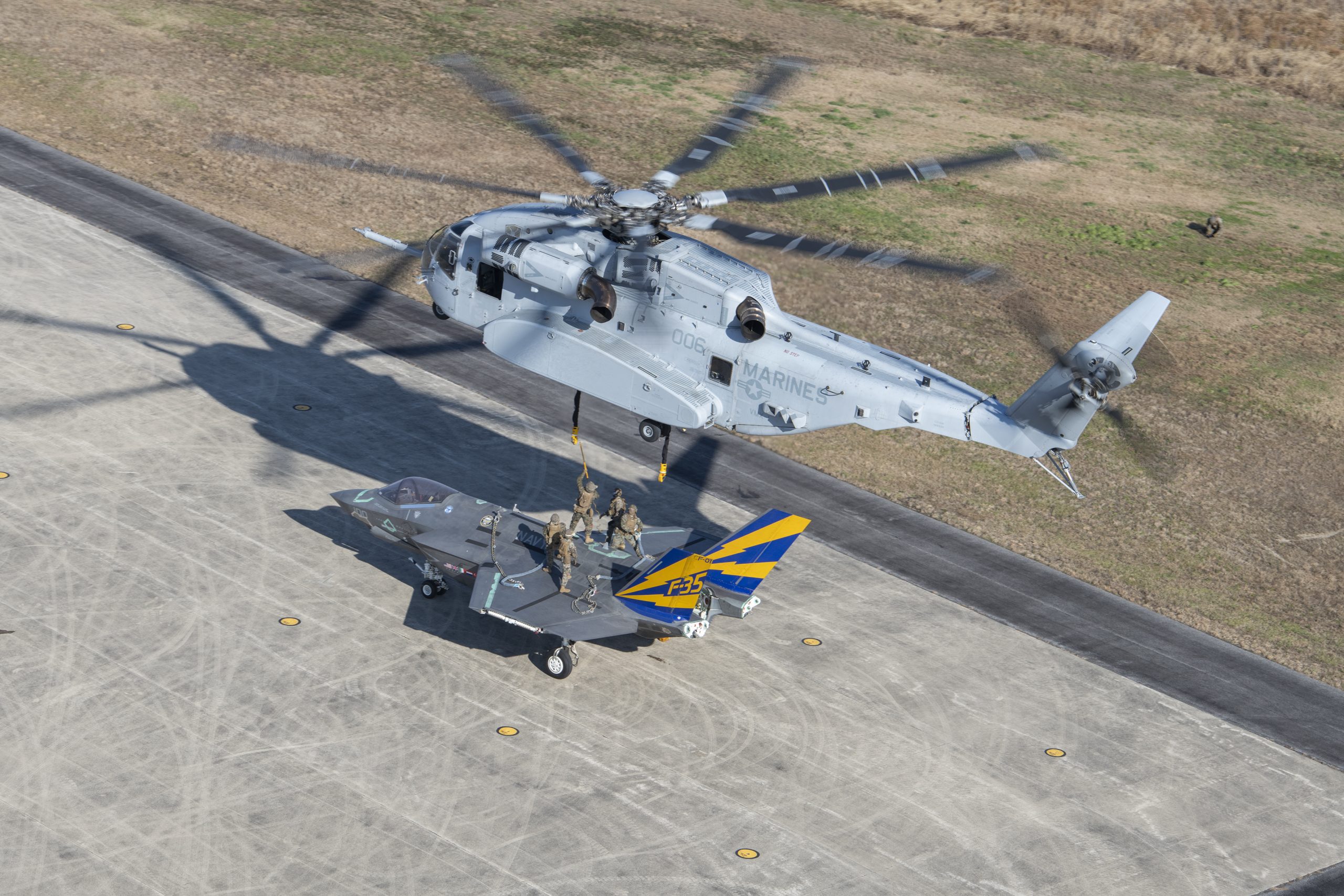 A non-flyable F-35C Lightning II airframe is prepared for a CH-53K King Stallion external load certification lift Dec. 13, 2022, at Naval Air Station Patuxent River, Md. The structure is from the first F-35C carrier variant aircraft, CF-1, a former developmental flight test jet from the Patuxent River F-35 Integrated Test Force (ITF). ITF test teams collaborated with Marine Operational Test and Evaluation Squadron One (VMX-1) and a Marine helicopter support team with Combat Logistics Battalion (CLB) 24, Combat Logistics Regiment 2, 2nd Marine Logistics Group to conduct the lift. The CLB-24 helicopter support team conducted operations to develop tactics, techniques, and procedures of CH-53K King Stallion utilization as the Marine Corps modernizes and prepares to respond globally to emerging crises or contingencies.