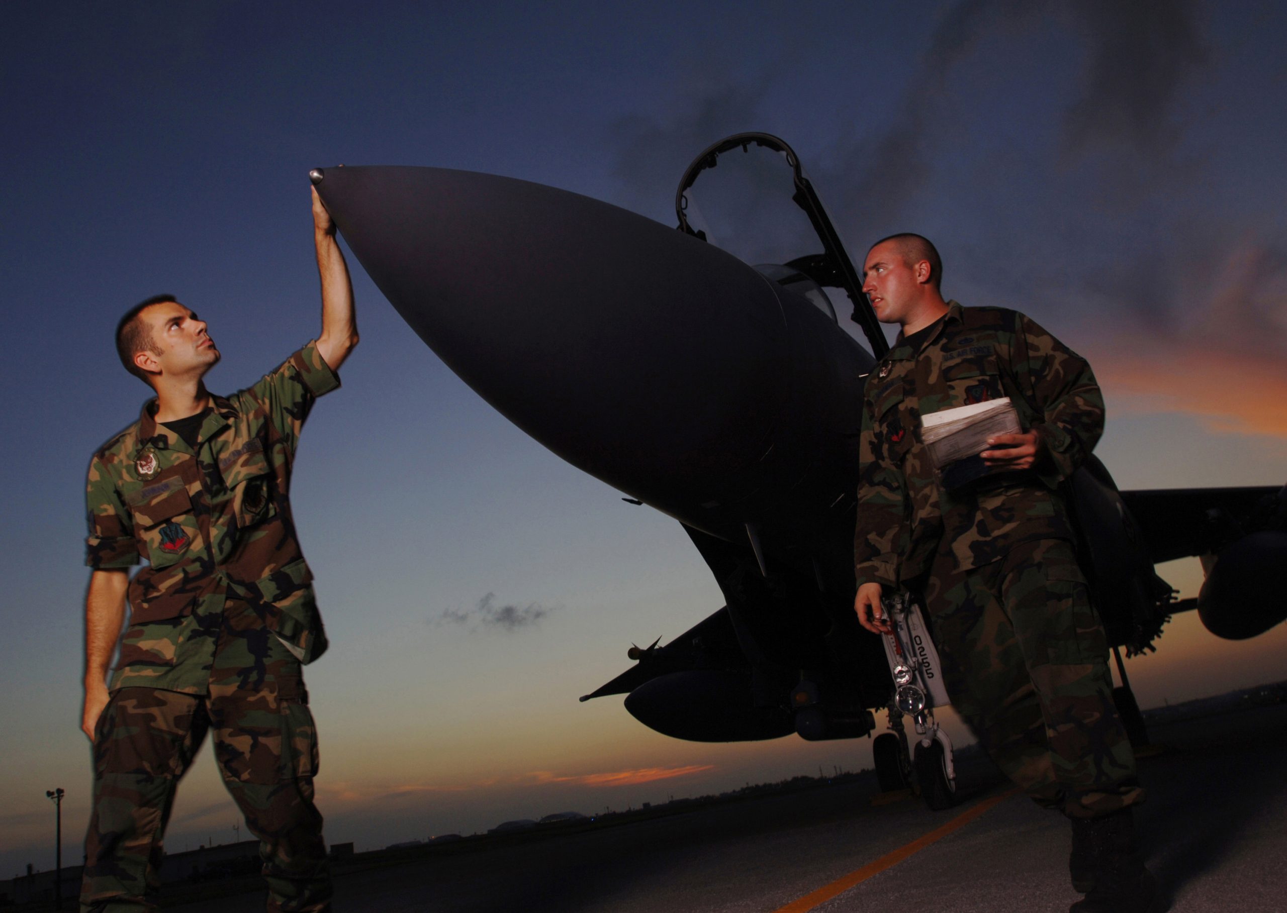 F-15 Eagle Crew Chiefs Staff Sgts. Andrew Johnson (left) and Brian Goodman inspect their aircraft on the flight line at Kadena Air Base, Japan, on Aug. 17, 2005. Johnson and Goodman are deployed to Kadena from the 391st Fighter Squadron, Mountain Home Air Force Base, Idaho, along with approximately 300 other Idaho airmen to support Pacific Command operations. (DoD photo by Master Sgt. Val Gempis, U.S. Air Force. (Released))