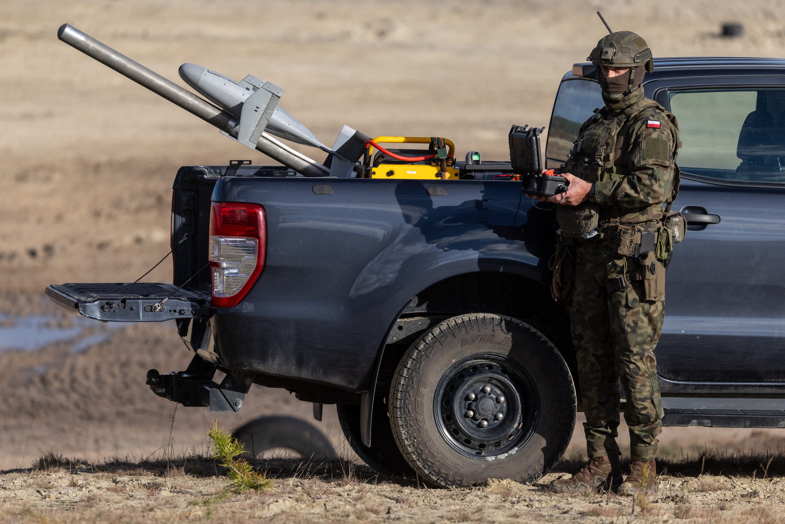 A Polish soldier launches an interception drone of the American MEROPS counter drone system during tests at the Nowa Deba military training ground, south-eastern Poland, on November 18, 2025. (Photo by Wojtek RADWANSKI / AFP) (Photo by WOJTEK RADWANSKI/AFP via Getty Images)
