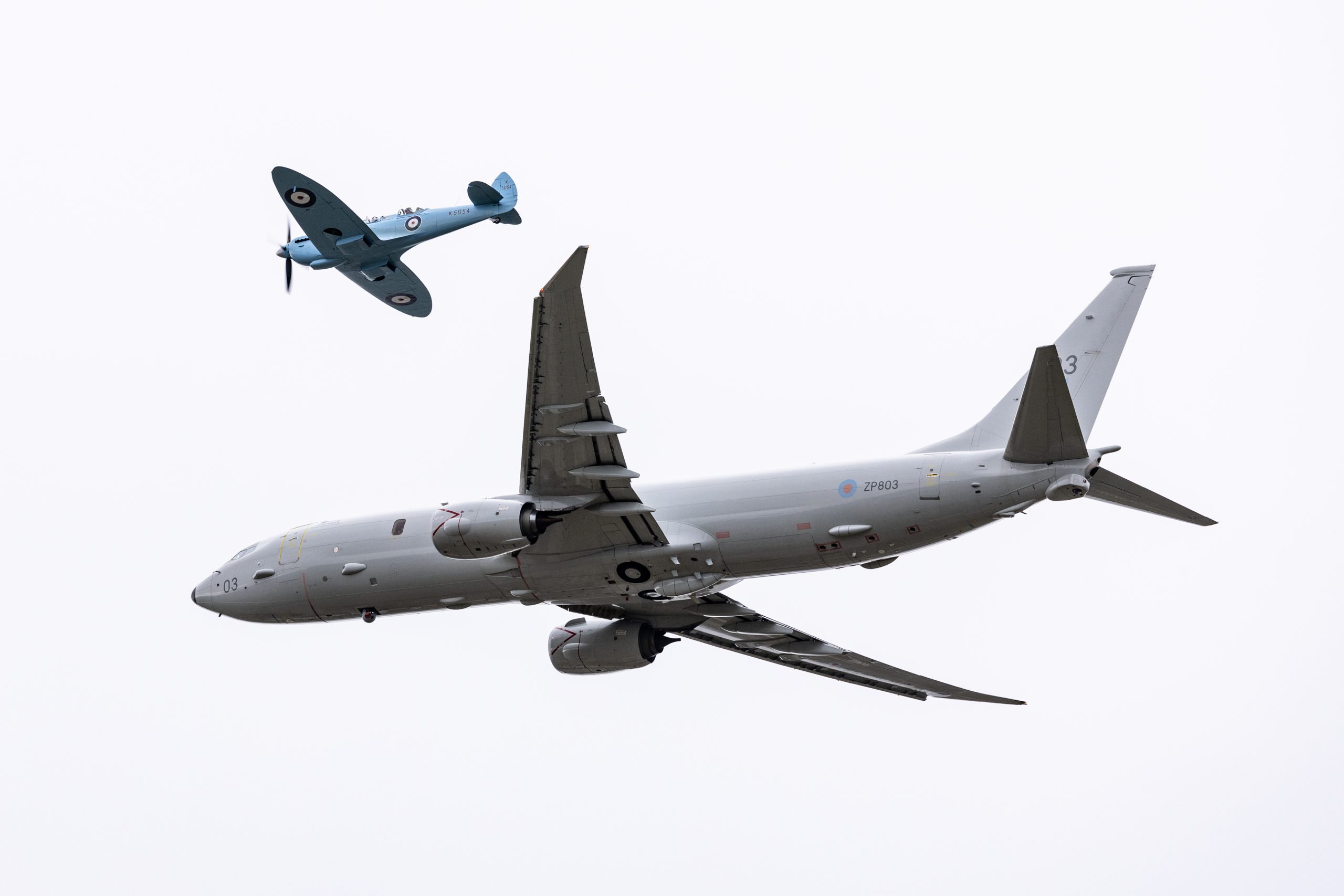 Image of a Spitfire aircraft, seen here flying with a P-8A maritime patrol aircraft over RAF Lossiemouth as part of it's tour (Spitfire 90) around the United Kingdom. SPITFIRE 90 is a collaborative commemorative event between the Battle of Britain Memorial Flight (BBMF) and Spitfires.com. The Spitfire Academy. Marking 90 years since the first flight of the Spitfire prototype K5054 from Eastleigh Aerodrome on 5 March 1936, a specially painted twin-seat Spitfire TR9 will complete a nine-leg circumnavigation of Great Britain, with each leg representing a decade of the aircraft’s history. Operating from nine UK locations between 7 and 17 April 2026, the event coordinates with current RAF aircraft to demonstrate the evolution of air power, while raising funds for the RAF Benevolent Fund and the Mark Long Trust.