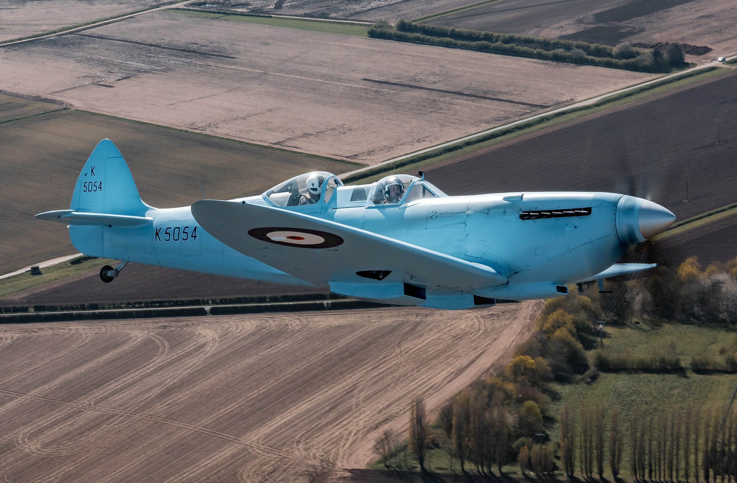 Image of Spitfire “K5054”, seen during transit to RAF Coningsby in the UK. The first flight of the eagerly anticipated commemorative Spitfire90 tour has successfully landed at RAF Coningsby. The nine flights have been organised to celebrate 90 years since the Supermarine Spitfire’s maiden flight. Departing from Southampton International Airport earlier today, the very site where Captain Joseph ‘Mutt’ Summers piloted the original Spitfire prototype K5054 on 5th March 1936, the specially painted two-seat Spitfire, replicating the original K5054, was escorted by the Dakota and Spitfire AB910 belonging to the Royal Air Force’s Battle of Britain Memorial Flight (BBMF) as it made its way to RAF Coningsby, the home of the BBMF. During the flight, "K5054" was also joined in the vicinity of RAF Marham by two F35 Lightning II aircraft.
