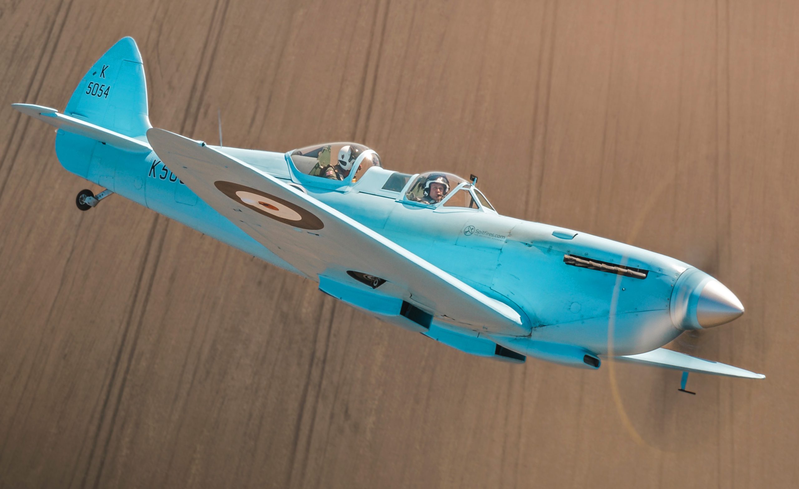 Image of Spitfire “K5054”, seen during transit to RAF Coningsby in the UK. The first flight of the eagerly anticipated commemorative Spitfire90 tour has successfully landed at RAF Coningsby. The nine flights have been organised to celebrate 90 years since the Supermarine Spitfire’s maiden flight. Departing from Southampton International Airport earlier today, the very site where Captain Joseph ‘Mutt’ Summers piloted the original Spitfire prototype K5054 on 5th March 1936, the specially painted two-seat Spitfire, replicating the original K5054, was escorted by the Dakota and Spitfire AB910 belonging to the Royal Air Force’s Battle of Britain Memorial Flight (BBMF) as it made its way to RAF Coningsby, the home of the BBMF. During the flight, "K5054" was also joined in the vicinity of RAF Marham by two F35 Lightning II aircraft.