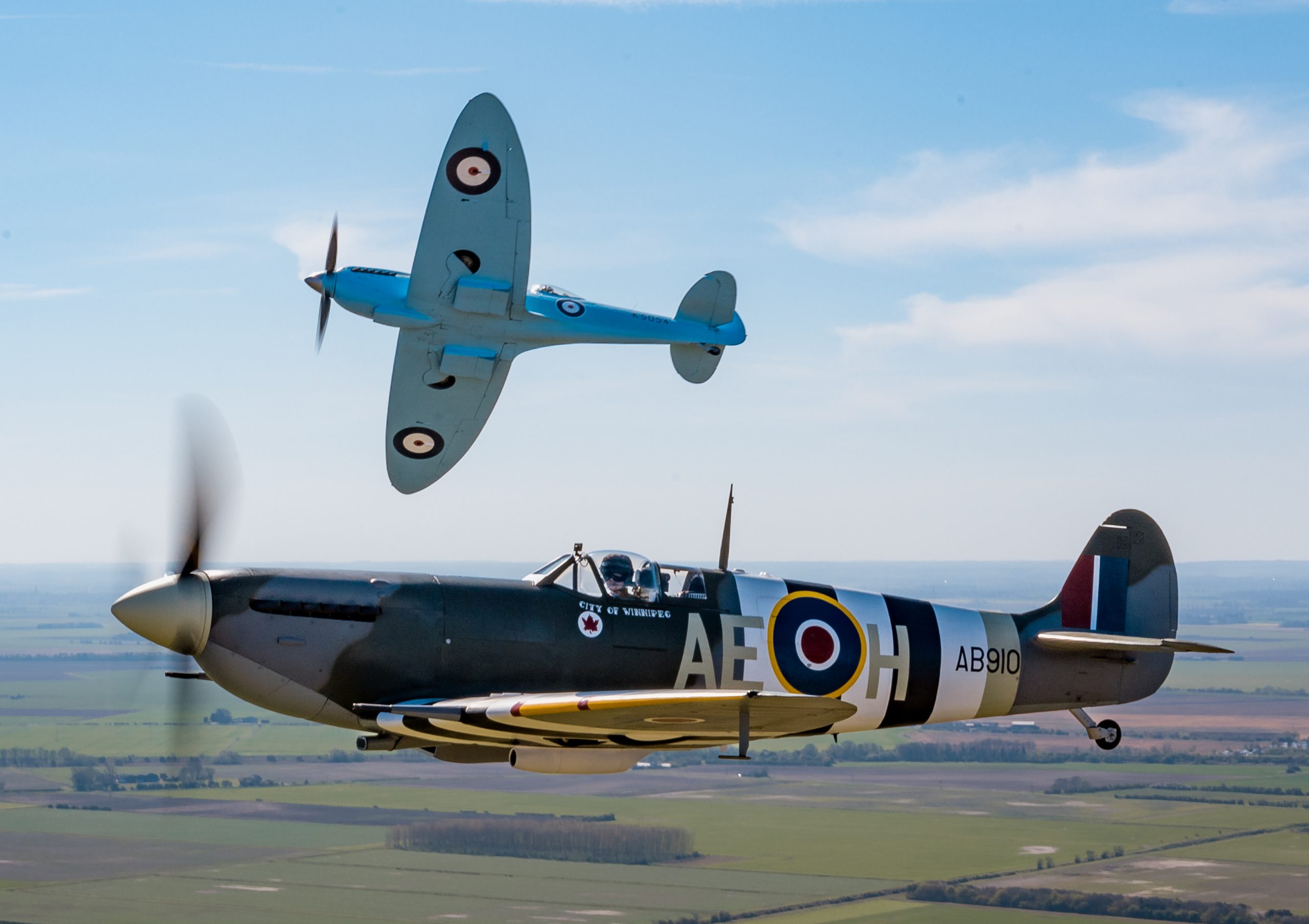 Image of Spitfire “AB910” and Spitfire “K5054”, seen during transit to RAF Coningsby in the UK. The first flight of the eagerly anticipated commemorative Spitfire90 tour has successfully landed at RAF Coningsby. The nine flights have been organised to celebrate 90 years since the Supermarine Spitfire’s maiden flight. Departing from Southampton International Airport earlier today, the very site where Captain Joseph ‘Mutt’ Summers piloted the original Spitfire prototype K5054 on 5th March 1936, the specially painted two-seat Spitfire, replicating the original K5054, was escorted by the Dakota and Spitfire AB910 belonging to the Royal Air Force’s Battle of Britain Memorial Flight (BBMF) as it made its way to RAF Coningsby, the home of the BBMF. During the flight, "K5054" was also joined in the vicinity of RAF Marham by two F35 Lightning II aircraft.
