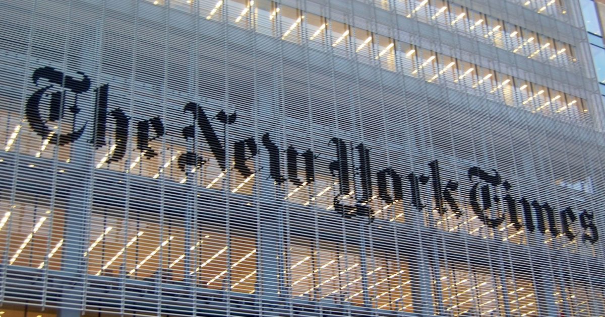 The New York Times logo displayed prominently on the building facade, showcasing modern architectural design and urban journalism.