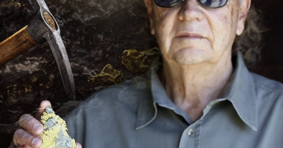 Miner holding a mineral specimen with a pickaxe in the background, showcasing the art of prospecting and geology.