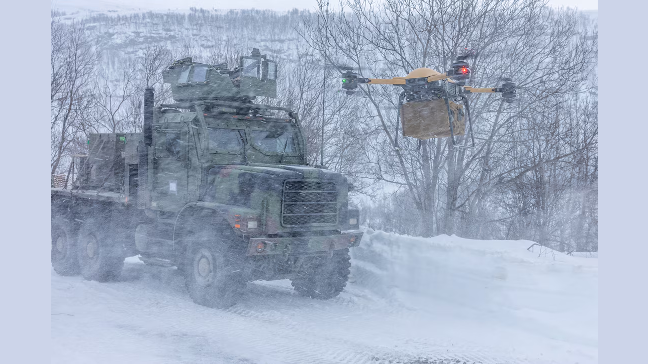 Military truck and drone in snowy landscape, demonstrating advanced logistics and supply delivery capabilities in harsh weather conditions.