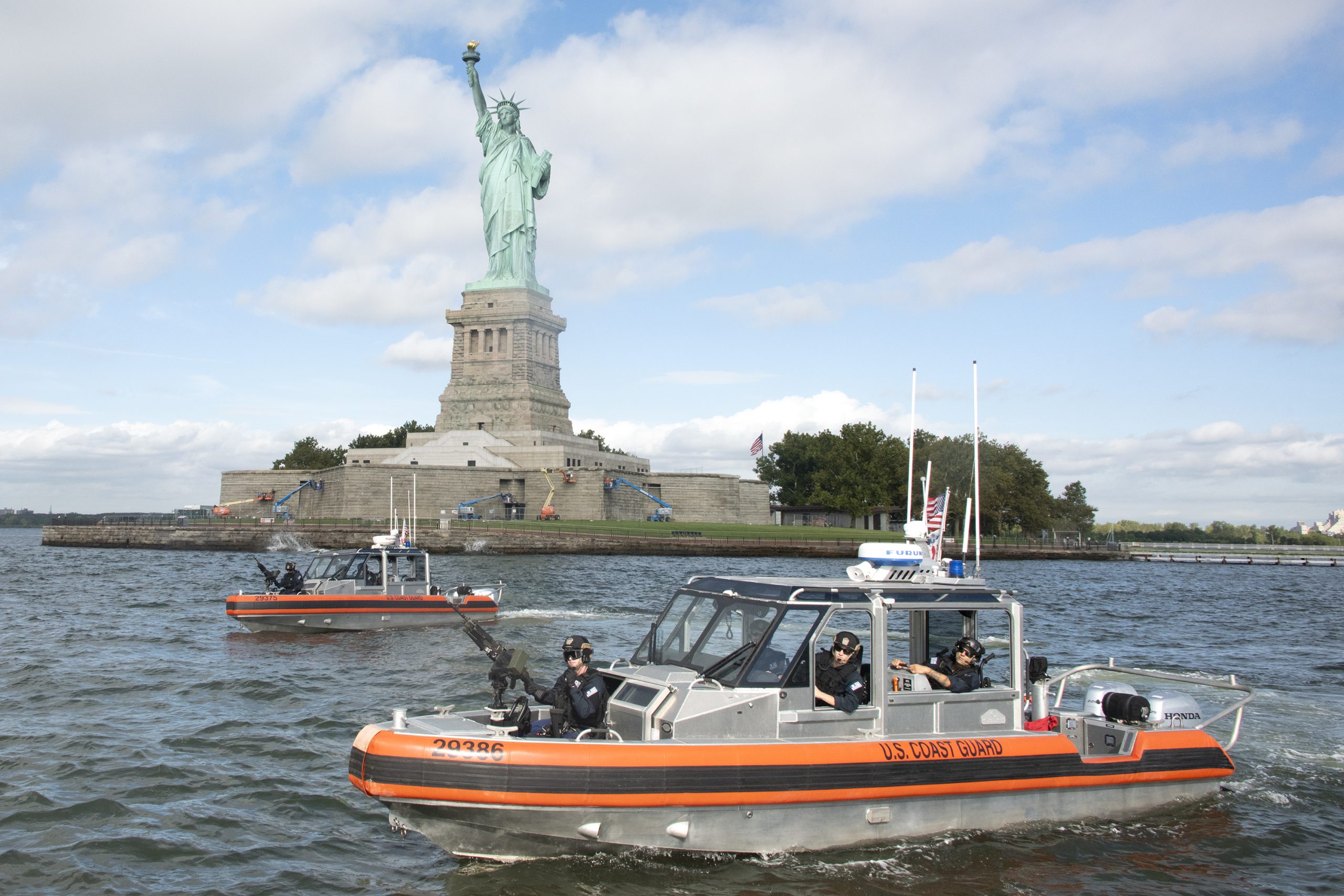 Coast Guard Maritime Safety and Security Team New York boat crews transit near the Statue of Liberty while escorting ferries in New York Harbor, Sept. 21, 2021. MSST New York is co-located with Coast Guard Station New York in Staten Island, New York. (U.S. Coast Guard photo by Petty Officer 2nd Class Cory J. Mendenhall)