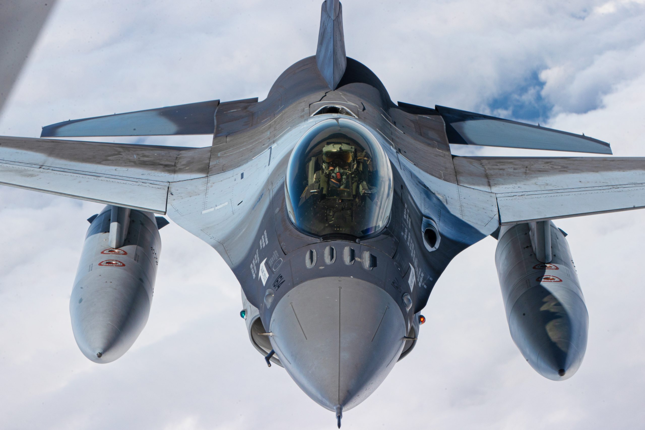 A Romanian Air Force pilot guides a F-16 fighter behind a KC-135 Stratotanker, assigned to the 117th Air Refueling Wing (ARW), during a joint training mission through the State Partnership Program between the Alabama National Guard and Romania, Romania, May 13, 2024. The 117th ARW conducts multiple mid-air refueling missions with the Romanian Air Force so they two can increase their own operational capabilities. (U.S. Army National Guard photo by Staff Sgt. Jaccob Hearn)