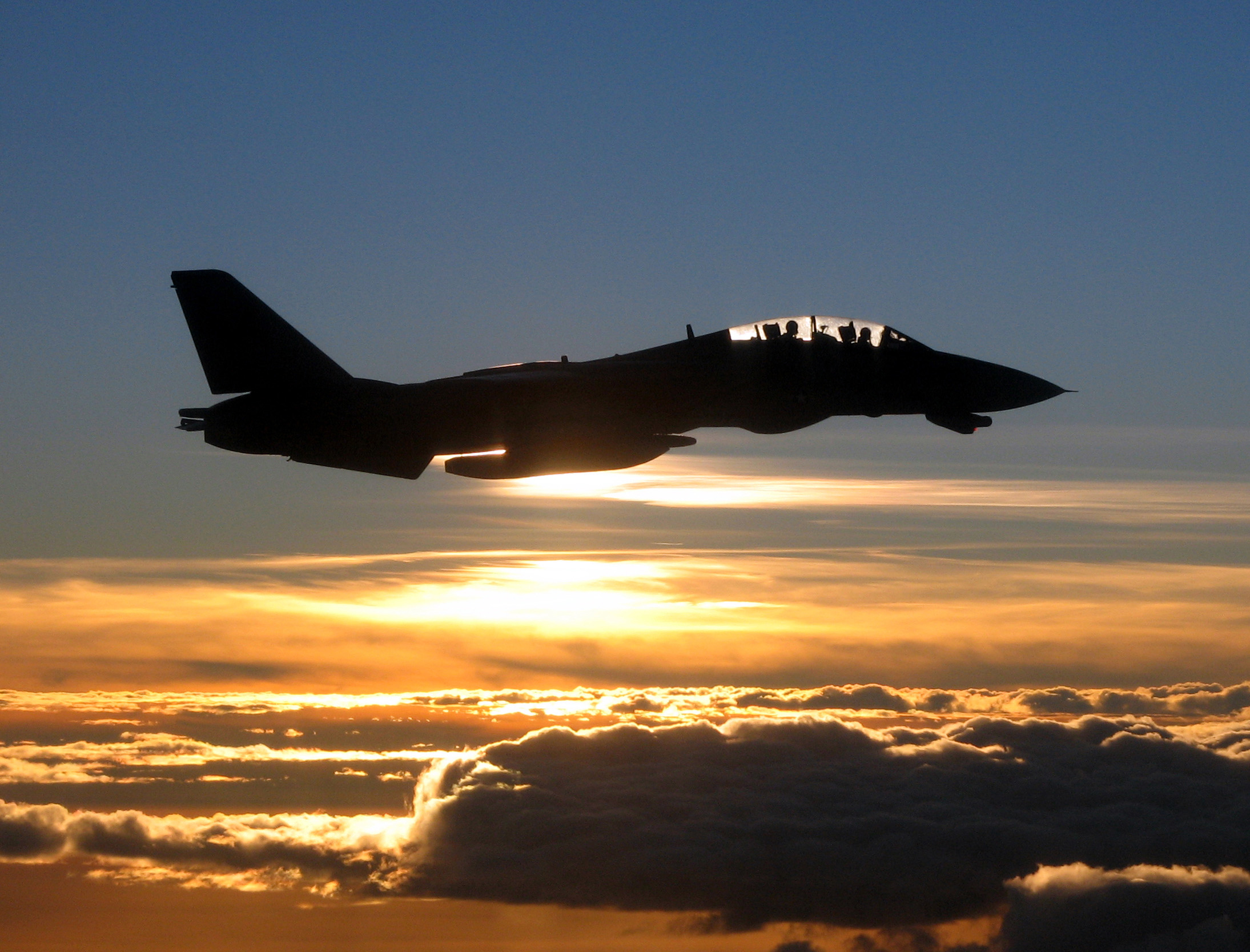 A Navy F-14D Tomcat is silhouetted against the sun as it flies a mission over the Persian Gulf on Dec. 4, 2005. The Tomcat and its crew are assigned to Fighter Squadron 213 and are operating off of the aircraft carrier USS Theodore Roosevelt (CVN 71). Roosevelt and its embarked Carrier Air Wing 8 are conducting maritime security operations in the Persian Gulf. (DoD photo by Lt. j.g. Scott Timmester, U.S. Navy. (Released))