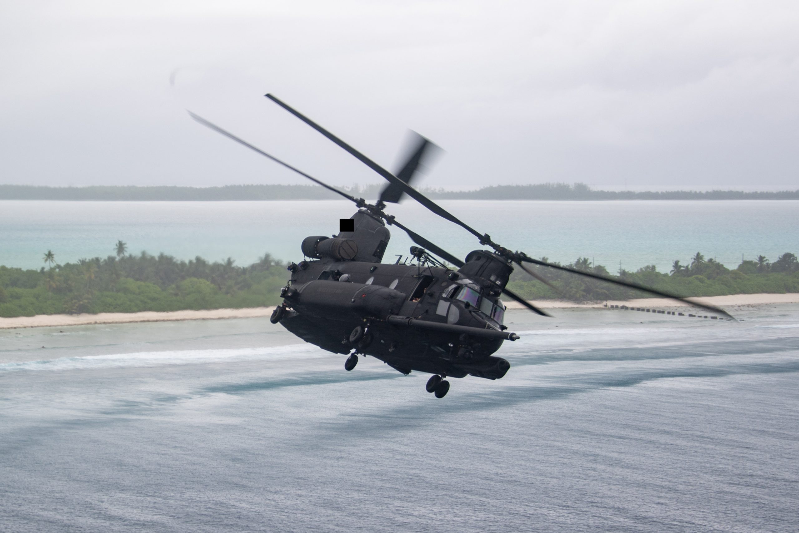 251014-N-ML137-1196 DIEGO GARCIA, British Indian Ocean Territory (Oct. 14, 2025) A MH-47G Chinook, attached to the “Night Stalkers” of U.S. Army 160th Special Operations Aviation Regiment, flies over Diego Garcia during a morale flight for service members stationed on the island, Oct. 14, 2025. U.S. Navy Support Facility Diego Garcia’s mission is to provide critical support to U.S. and allied forces forward deployed to the Indian Ocean, while supporting multi-theater forces operating in the CENTCOM, AFRICOM, EUCOM and PACOM areas of responsibilities in support of overseas contingency operations. (U.S. Navy photo illustration by Mass Communication Specialist 1st Class Samantha Jetzer)