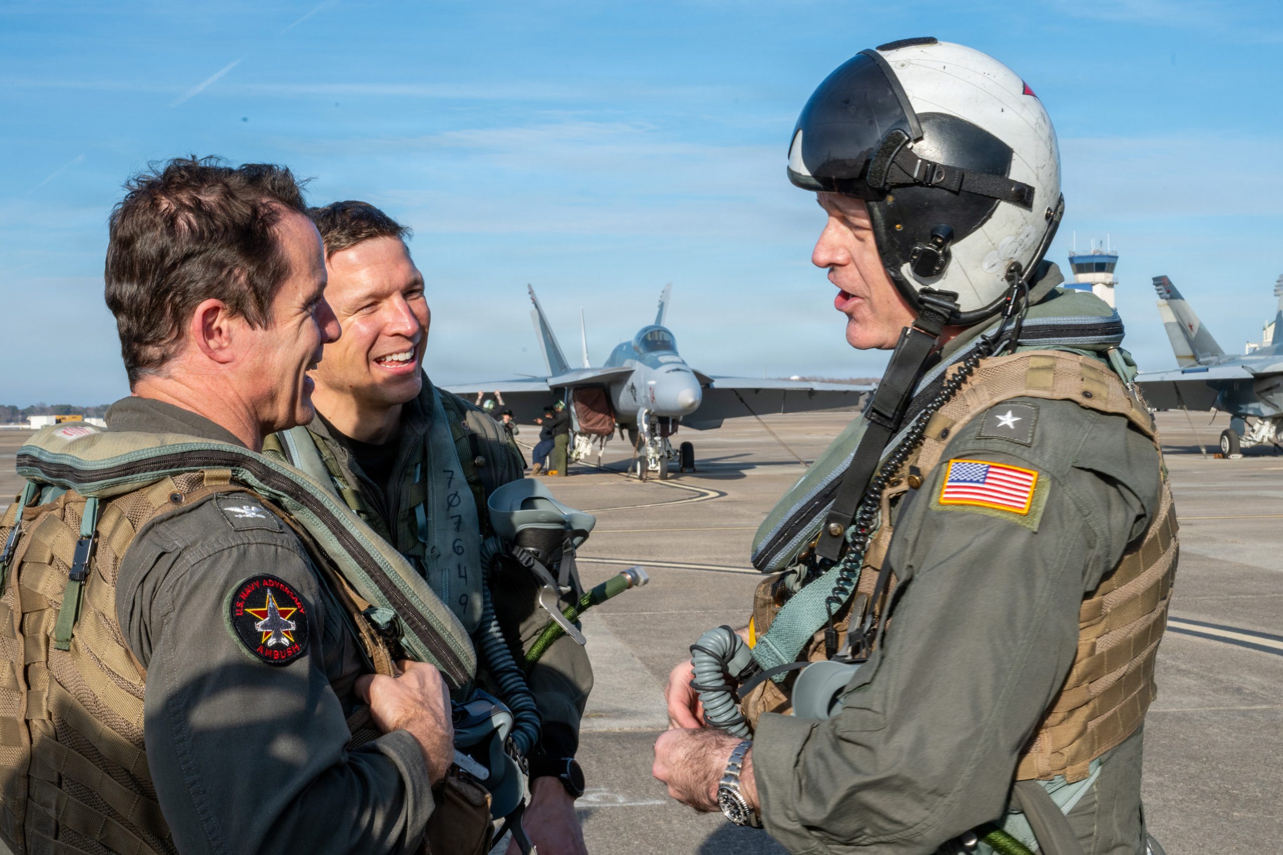 Rear Adm. Richard S. Lofgren, acting Chief of Navy Reserve, right, speaks with Capt. Borya I. Celentano, Commander, Tactical Support Wing, left, and U.S. Navy Cmdr. Matt Simmons, commanding officer of Fighter Squadron Composite Twelve (VFC-12), after a familiarization flight at Naval Air Station Oceana, Virginia on Feb. 17, 2026. VFC-12 provides adversary training to prepare fighter squadrons for combat operations. The squadron is part of the Navy Reserve’s Tactical Support Wing and is integral in maintaining fleet combat readiness. (U.S. Navy photo by Mass Communication Specialist 1st Class David C. Warren)