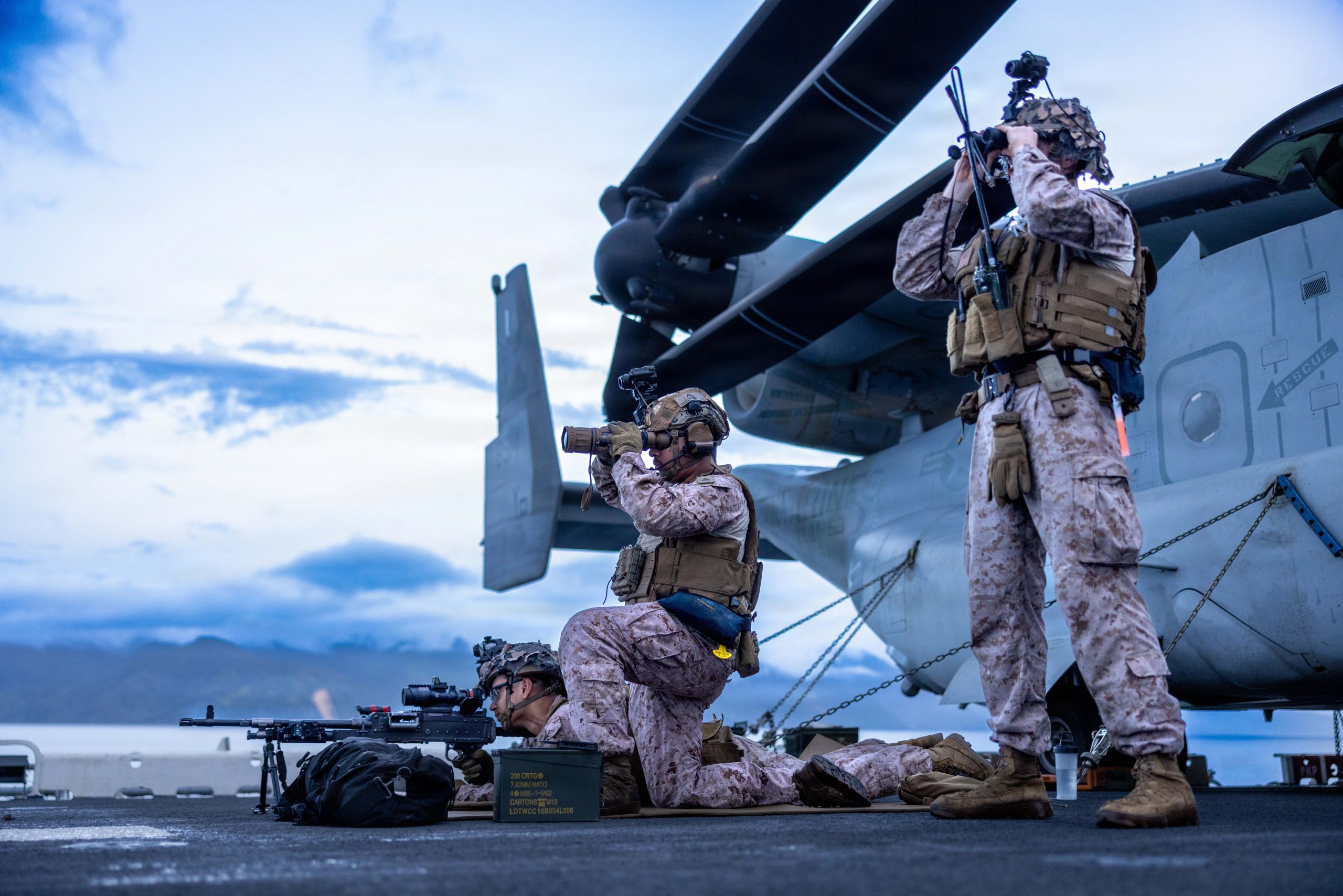 U.S. Marines with Battalion Landing Team 3/5, 11th Marine Expeditionary Unit, scan for vessels on the flight deck of Wasp-class amphibious assault ship USS Boxer (LHD 4) while transiting the Surigao Strait, April 26, 2026. The 11th MEU, embarked aboard the Boxer Amphibious Ready Group, is a persistent, combat credible force contributing to deterrence and crisis response in the U.S. 7th Fleet area of operations. U.S. 7th Fleet, the U.S. Navy's largest forward-deployed numbered fleet, routinely interacts and operates with allies and partners to preserve a free and open Indo-Pacific. (U.S. Marine Corps photo by Trent A. Henry)