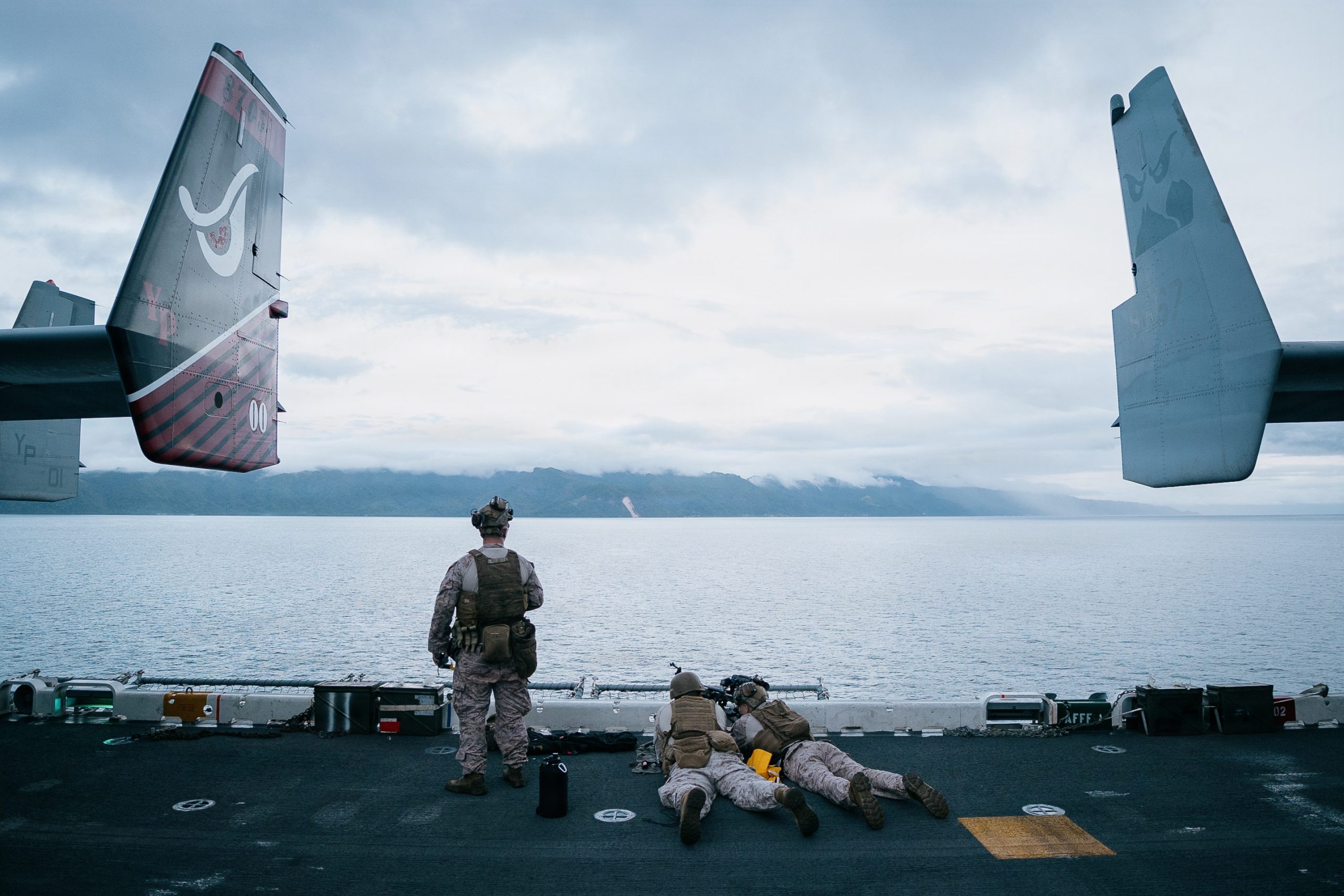 U.S. Marines with Light Armored Reconnaissance Company, Battalion Landing Team 3/5, 11th Marine Expeditionary Unit, scan for vessels on the flight deck of Wasp-class amphibious assault ship USS Boxer (LHD 4) while transiting the Surigao Strait, April 26, 2026. The 11th MEU, embarked aboard the Boxer Amphibious Ready Group, is a persistent, combat credible force contributing to deterrence and crisis response in the U.S. 7th Fleet area of operations. U.S. 7th Fleet, the U.S. Navy's largest forward-deployed numbered fleet, routinely interacts and operates with allies and partners to preserve a free and open Indo-Pacific. (U.S. Marine Corps photo by Sgt. Joseph Helms)