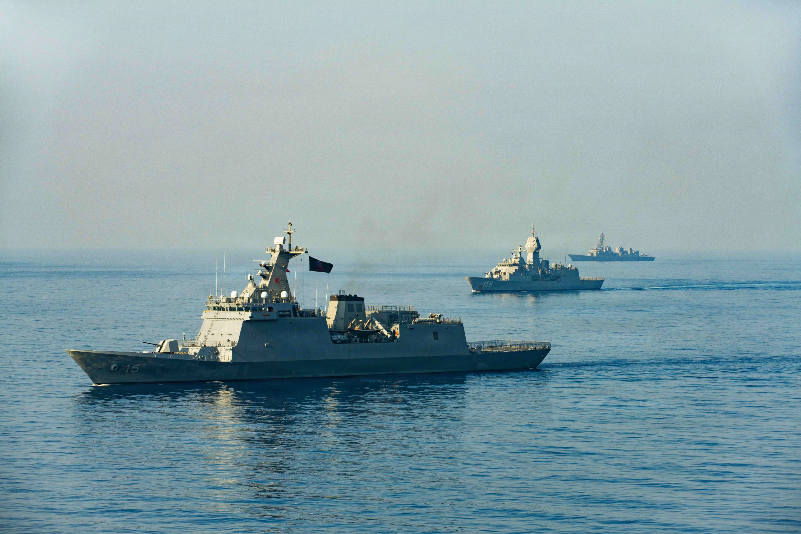 Philippine Navy Jose Rizal-class guided-missile frigate BRP Antonio Luna (FFG 15), left, Royal Australian Navy Anzac-class frigate HMAS Toowoomba (FFH 156), center, and Japan Maritime Self-Defense Force Murasame-class destroyer JS Ikazuchi (DD107) transit in formation during the group sail exercise for Exercise Balikatan 2026 in the South China Sea, April 24, 2026. Balikatan is a longstanding annual exercise between the Armed Forces of the Philippines and U.S. military that represents the strength of our alliance, improves our capable combined force, and demonstrates our commitment to regional peace and prosperity. (U.S. Marine Corps photo by Cpl. Kenneth Twaddell)