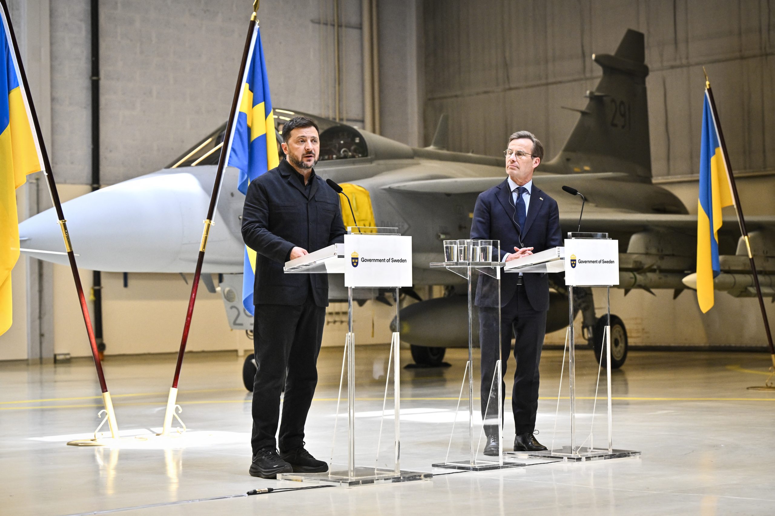 Ukraine's President Volodymyr Zelensky (L) and Swedish Prime Minister Ulf Kristersson address a press conference at the F16 air flotilla in Uppsala, Sweden on May 28, 2026. Ukraine plans to buy up to 20 latest model Gripen fighter jets and Sweden will donate 16 older models to boost its air defence, the two countries said on May 28, 2026 during a surprise visit to Sweden by the Ukrainian president. Ukraine plans to allocate 2.5 billion euros ($2.9 billion) from an EU loan for the new aircraft, the Swedish government said in a statement. (Photo by Christine Olsson/TT / various sources / AFP via Getty Images) / Sweden OUT