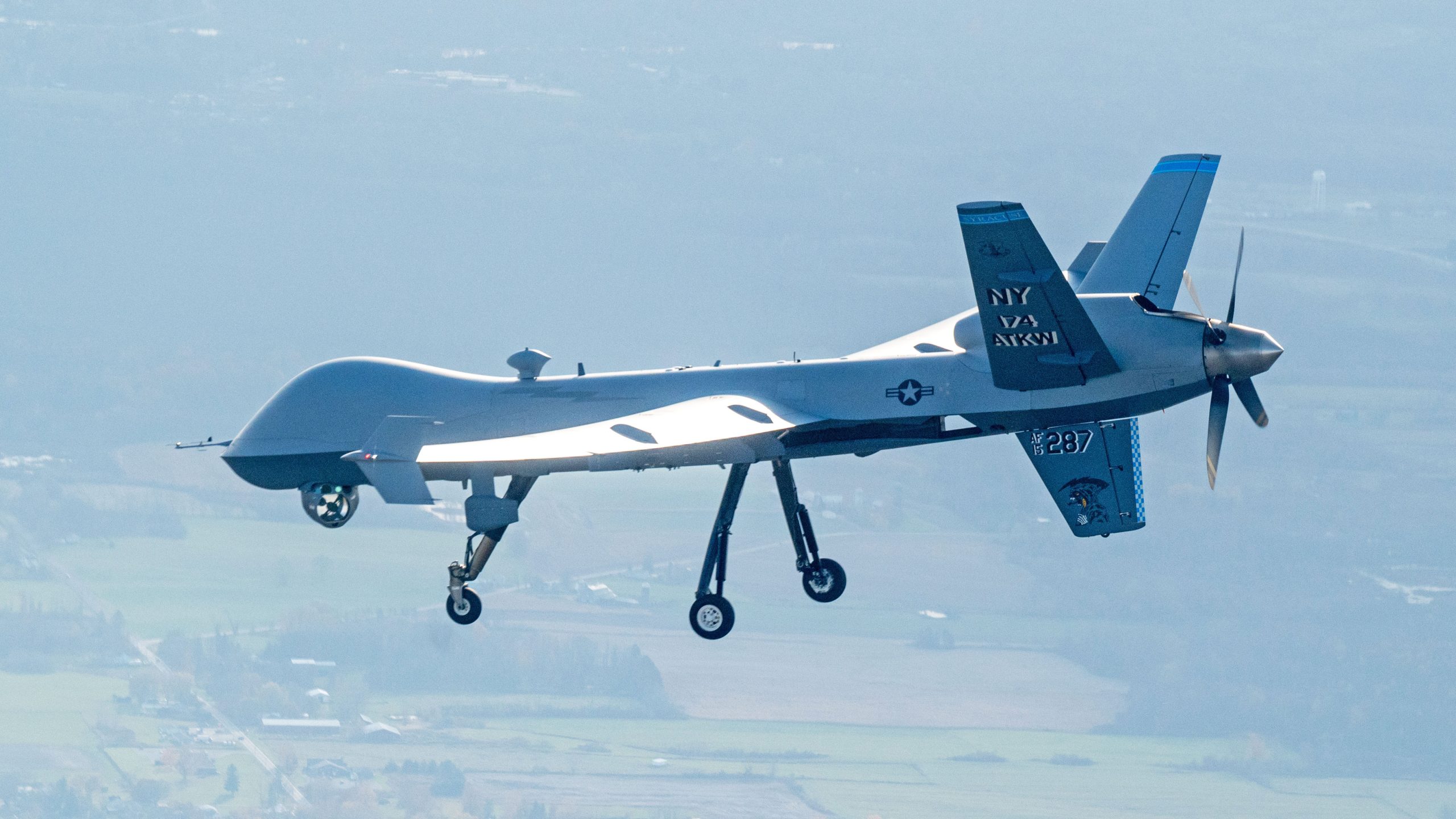 A MQ-9 Reaper assigned to the 174th Attack Wing flies over Hancock Field Air National Guard Base, Syracuse, NY, following a routine training flight, Oct. 31, 2024. The 108th Attack Squadron conducts these flights to instruct pilots and sensor operators on proper flight operations of the aircraft. (U.S. Air National Guard photo by Senior Airman Dylan McCrink)