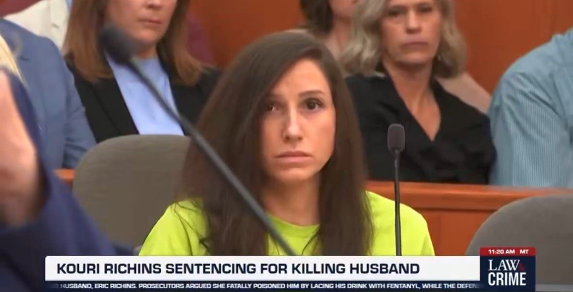 Kouri Richins appears in court during her sentencing for the murder of her husband, facing serious charges amid a courtroom audience.