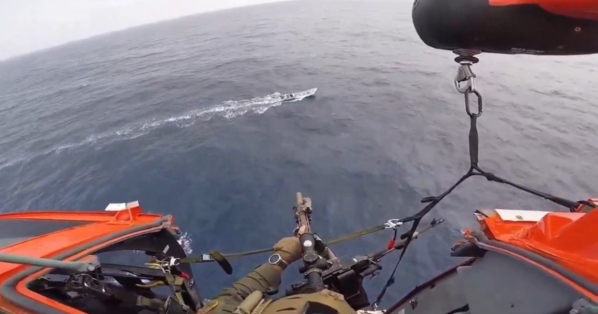 View from a helicopter hovering above the ocean, showcasing a rescue operation with a soldier aiming a weapon at a distant boat.