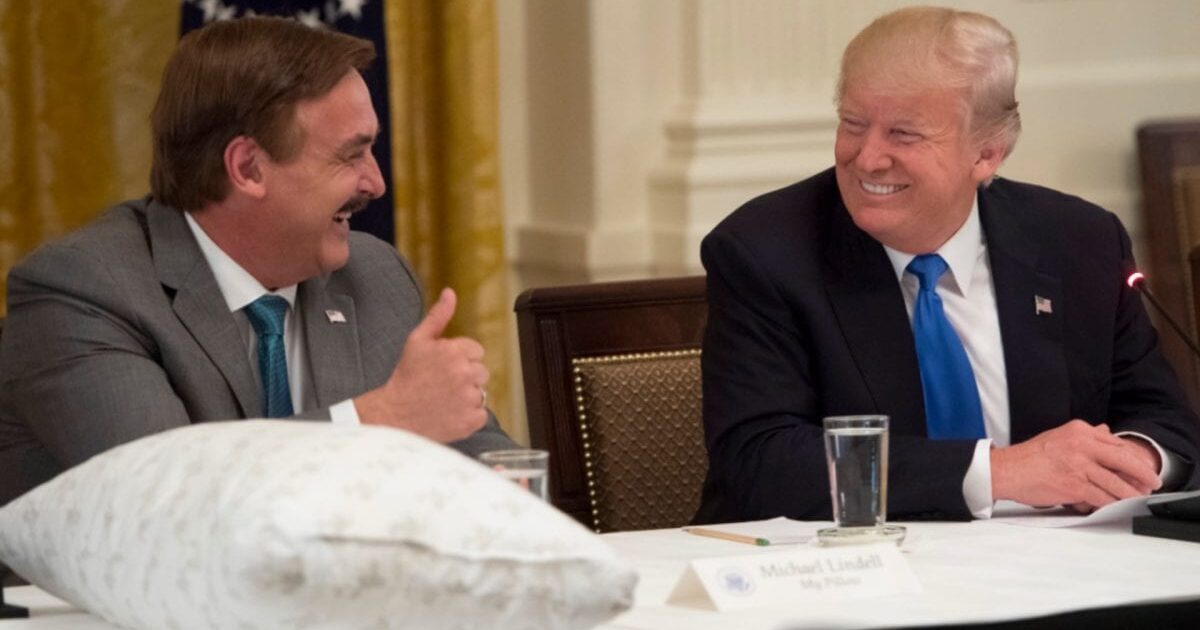 Donald Trump and Mike Lindell share a light-hearted moment during a meeting at the White House, showcasing camaraderie and discussion.