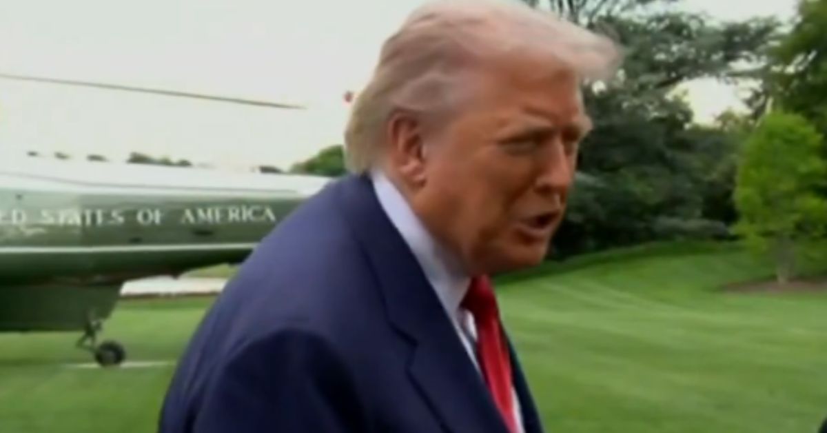 Former President Donald Trump speaking outdoors near a helicopter at the White House, surrounded by greenery.