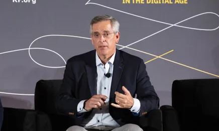 Business professional speaking at a conference on digital transformation, emphasizing key insights and strategies in the digital age.