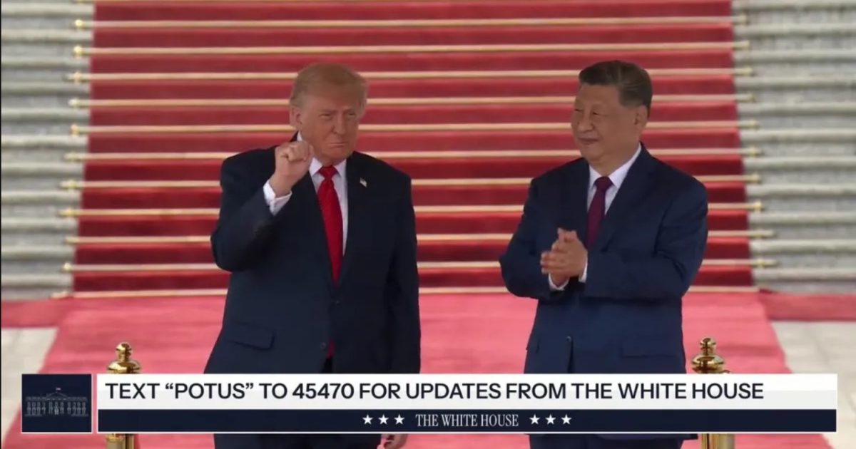 Former US President Donald Trump and Chinese President Xi Jinping stand together on a red carpet during a formal event, showcasing international diplomatic relations.