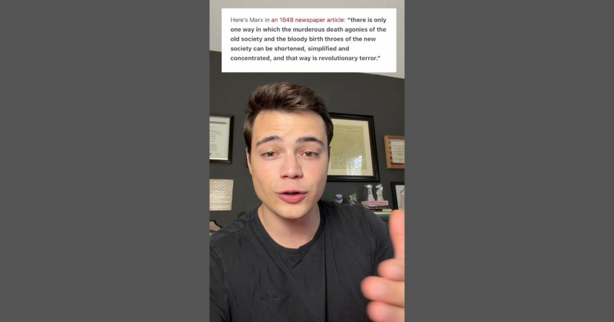 A young man discusses a quote from a 1848 newspaper article by Marx about societal change and revolutionary ideas.