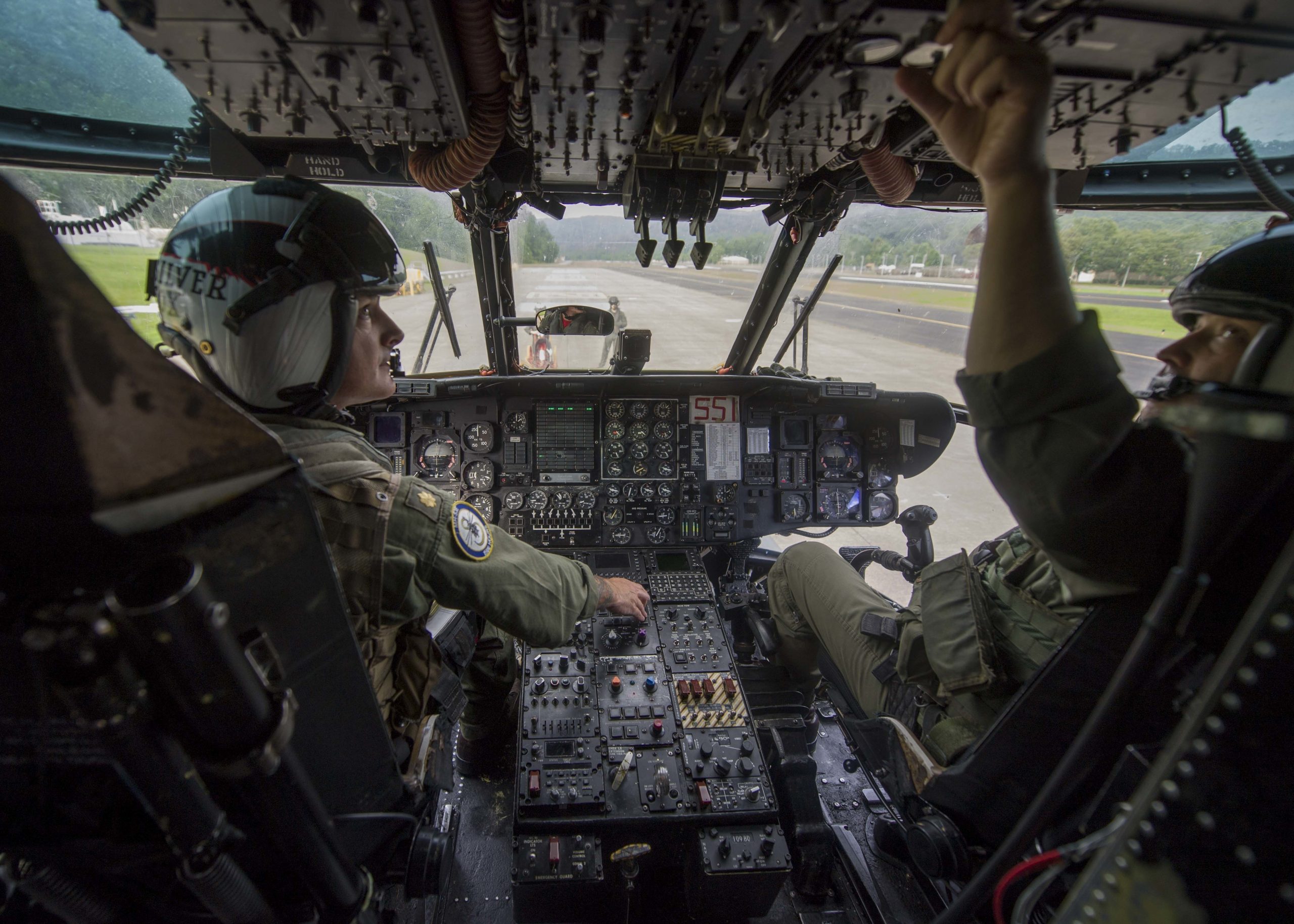 170727-N-TJ319-085 CAMP DAWSON, W. Va. (July 27, 2017) Lt. Cmdr. Jeff Spencer and Lt. Cmdr. Bochette, assigned to the Vanguards of Helicopter Mine Countermeasures Squadron (HM) 14, perform a pre-flight check on an MH-53 helicopter. The squadron visited Camp Dawson Army National Guard Facility to conduct a four-day aerial mountainous terrain familiarization training. (U.S. Navy photo by Mass Communication Specialist Seaman Jessica L. Dowell/Released)