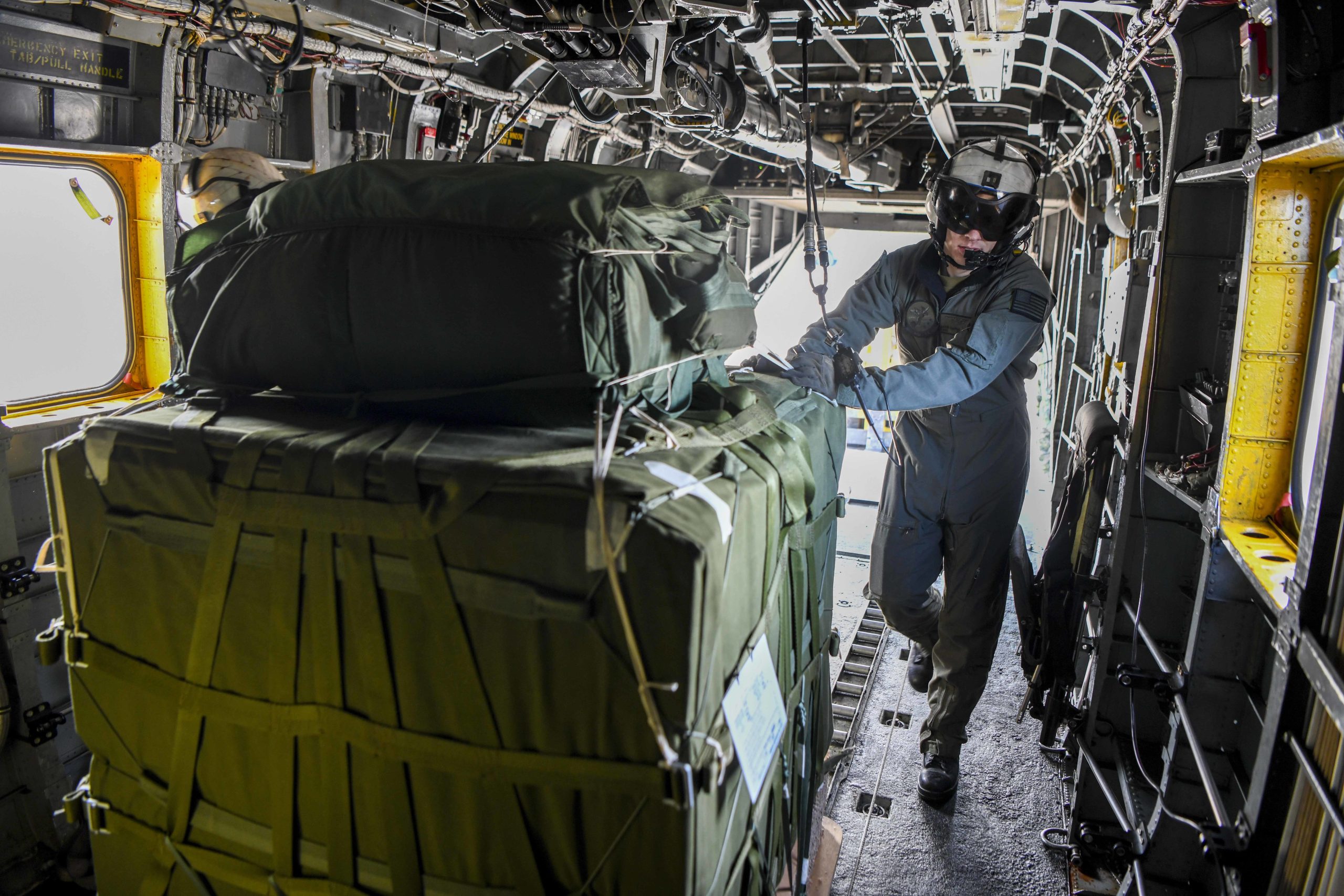 221701-N-ZU710-0054 REPUBLIC OF KOREA (Jan. 17, 2022) Aviation Warfare Systems Operator 2nd Class Gavin Chatham prepares to push cargo out of an MH-53 Sea Dragon helicopter from Helicopter Mine Countermeasures Squadron 14 (HM-14). HM-14 was conducting routine training in the Republic of Korea. (U.S. Navy Photo by Mass Communication Specialist 2nd Class Michael Chen/Released)