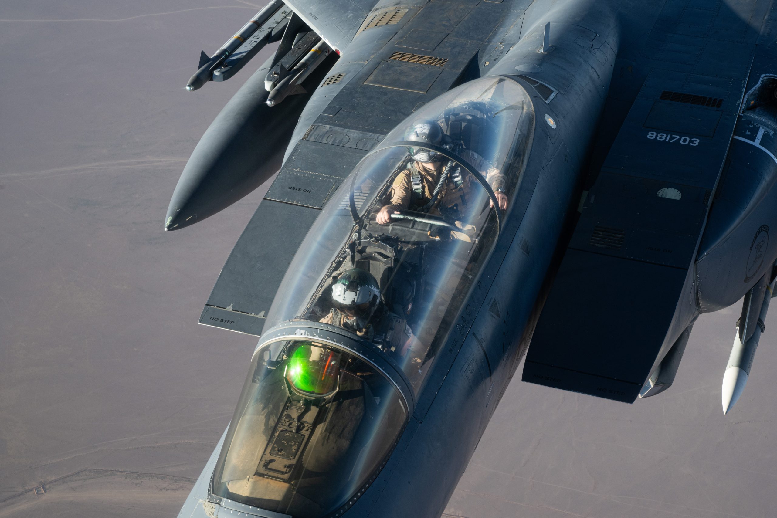 A U.S. Air Force F-15E Strike Eagle pilot and weapons systems officer assigned to the 335th Expeditionary Fighter Squadron, Seymour Johnson Air Force Base, North Carolina, prepares to receive fuel from a KC-135 Stratotanker assigned to the 92nd Expeditionary Air Refueling Squadron, Fairchild Air Force Base, Washington, over the U.S. Central Command (USCENTCOM) area of responsibility (AOR), Sept 16, 2024. The F-15E is a two-seat, dual-role, fighter with a rear cockpit allowing for a weapons system officer to manage weapons and aircraft systems while conducting operations that provide safety and security for the U.S. regional partners and coalition allies within the USCENTCOM AOR. (U.S. Air Force photo)