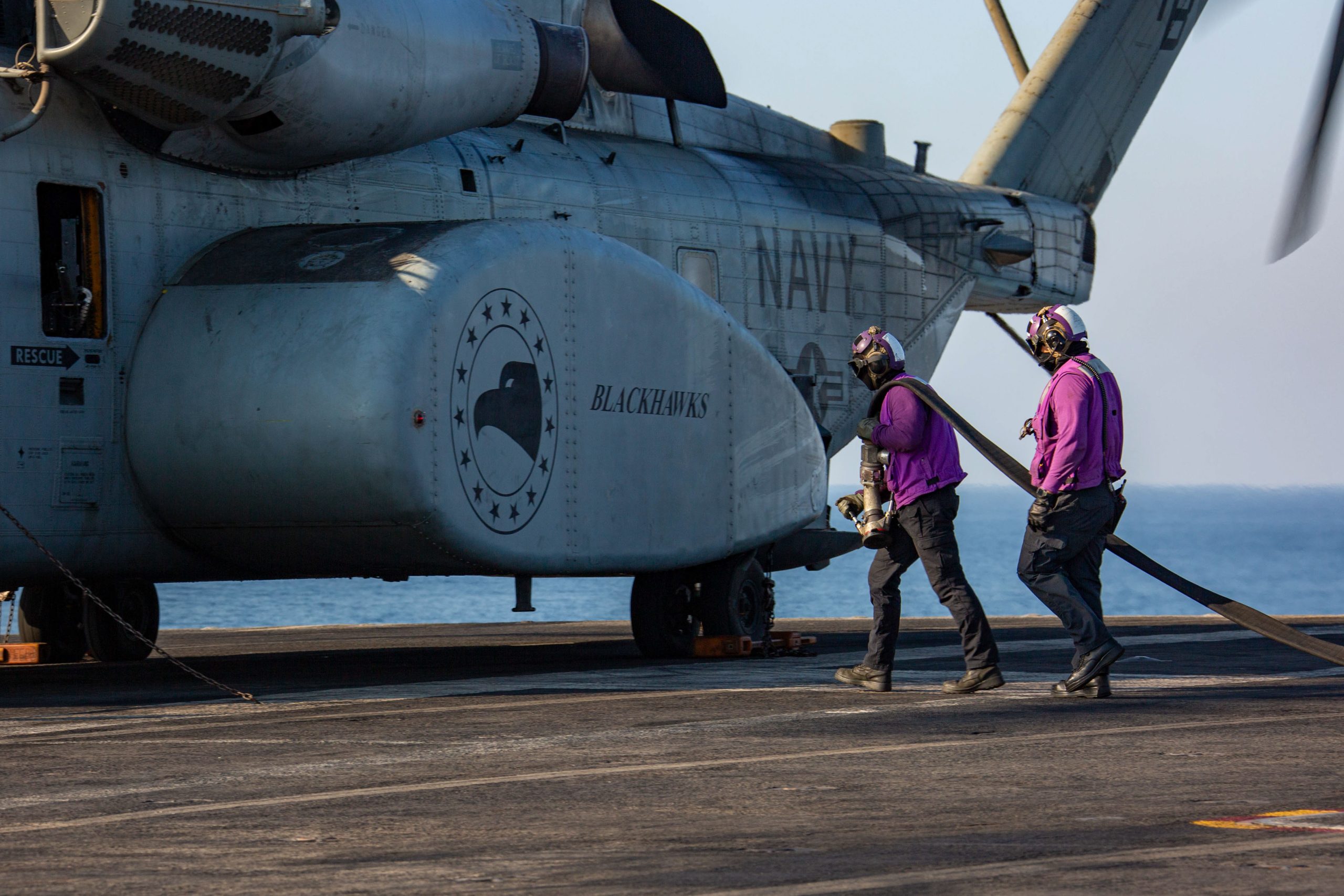 241030-N-AB116-7409 U.S. CENTRAL COMMAND AREA OF RESPONSIBILITY (Oct. 30, 2024) U.S. Navy Aviation Boatswain’s Mates (Fueling) prepare to refuel an MH-53E Sea Dragon helicopter, attached to Helicopter Mine Countermeasures Squadron (HM) 15, on the flight deck of the Nimitz-class aircraft carrier USS Abraham Lincoln (CVN 72). (Official U.S. Navy photo)