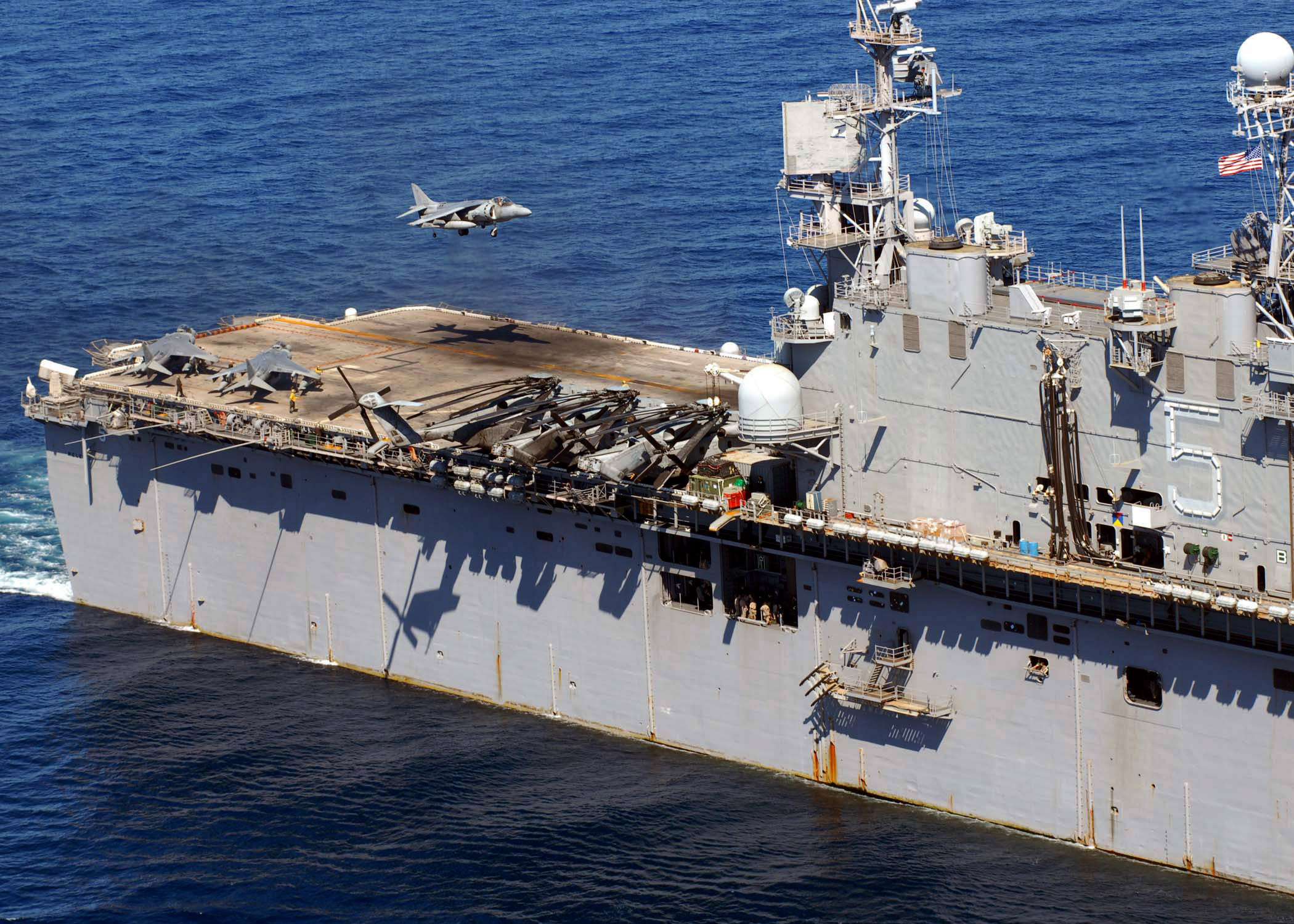 An AV-8B Harrier assigned to Marine Attack Squadron (VMA) 311 lands aboard the Tarawa-class amphibious assault ship USS Peleliu (LHA 5) as it steams through the South China Sea. Peleliu is the flaghsip of the Peleliu Expeditionary Strike Group and is on a scheduled deployment. (U.S. Navy photo/Petty Officer 2nd Class Scott Webb)