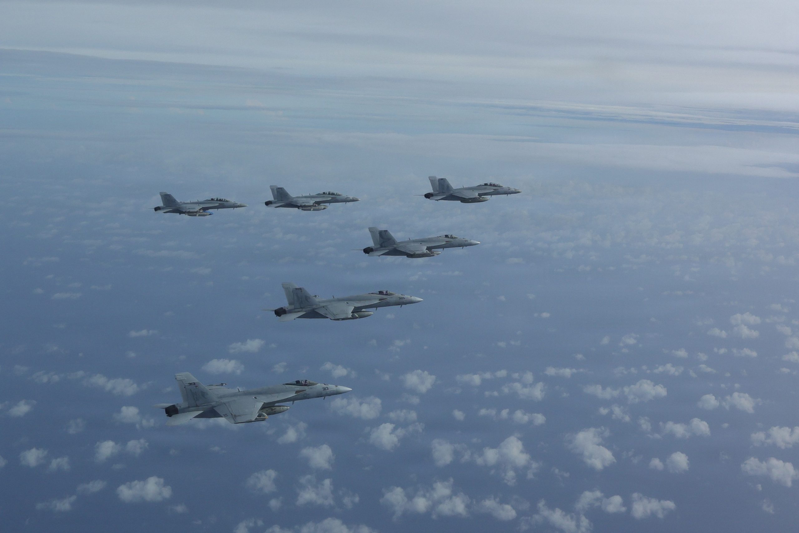 F/A-18E Super Hornets attached to the “Kestrels” of Strike Fighter Squadron (VFA) 137, fly in formation during an air power demonstration over the Gulf of America, June 11, 2026. U.S. military forces are deployed to the U.S. Southern Command area of responsibility in support of Department of War-directed operations, and the president's priorities to disrupt illicit drug trafficking, deter malign actors and protect the homeland through continuous presence. Nimitz-class aircraft carriers are the pinnacle of mobile naval air power projection and forward operational presence. No other weapons system possesses the responsiveness, endurance, multi-dimensional might, inherent battlespace awareness, and command and control capabilities of a carrier strike group and its embarked air wing. (U.S. Navy photo by LT Will "Simple Will" Shortal/ Released)