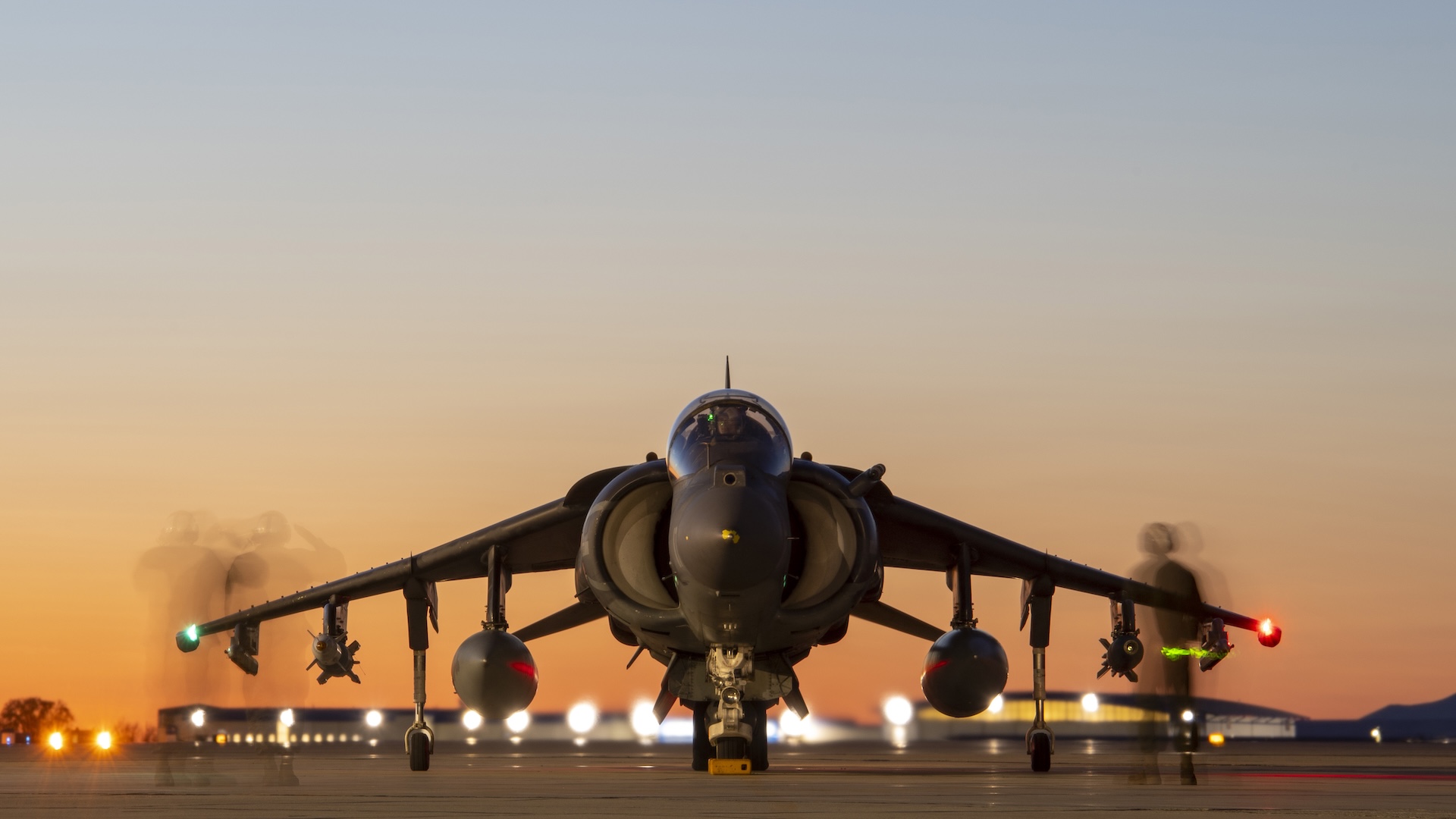 A Marine plane captain, from Marine Attack Squadron 223, Cherry Point, North Carolina, observes pre-flight checks of an AV-8B Harrier at Gowen Field, Boise, Idaho, April 19, 2021. The checks are designed to operational check various flight controls of the aircraft.