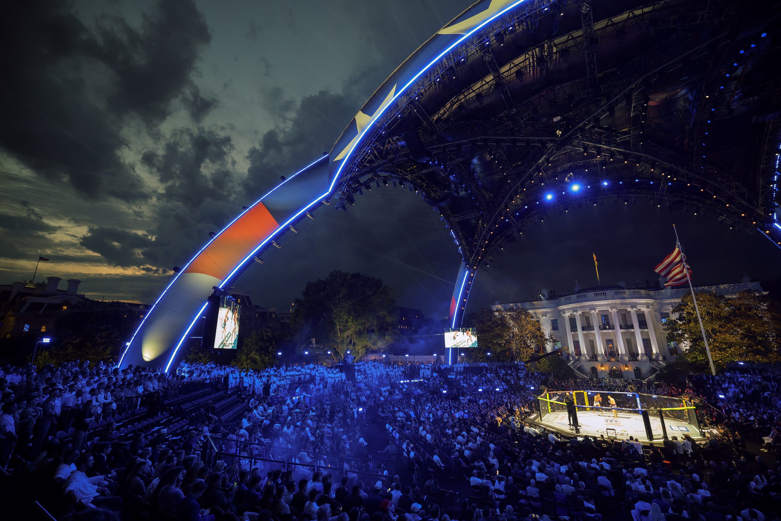 WASHINGTON, DC - JUNE 14: Guests, including members of the U.S. military, attend the Ultimate Fighting Championship (UFC) Freedom 250 mixed martial arts event under the open-air "Claw" on the South Lawn of the White House on June 14, 2026 in Washington, DC. On his 80th birthday, President Donald Trump hosted a series of seven mixed martial arts fights on the South Lawn, which the White House is calling "a once-in-a-generation celebration of the American fighting spirit." (Photo by Chip Somodevilla/Getty Images)