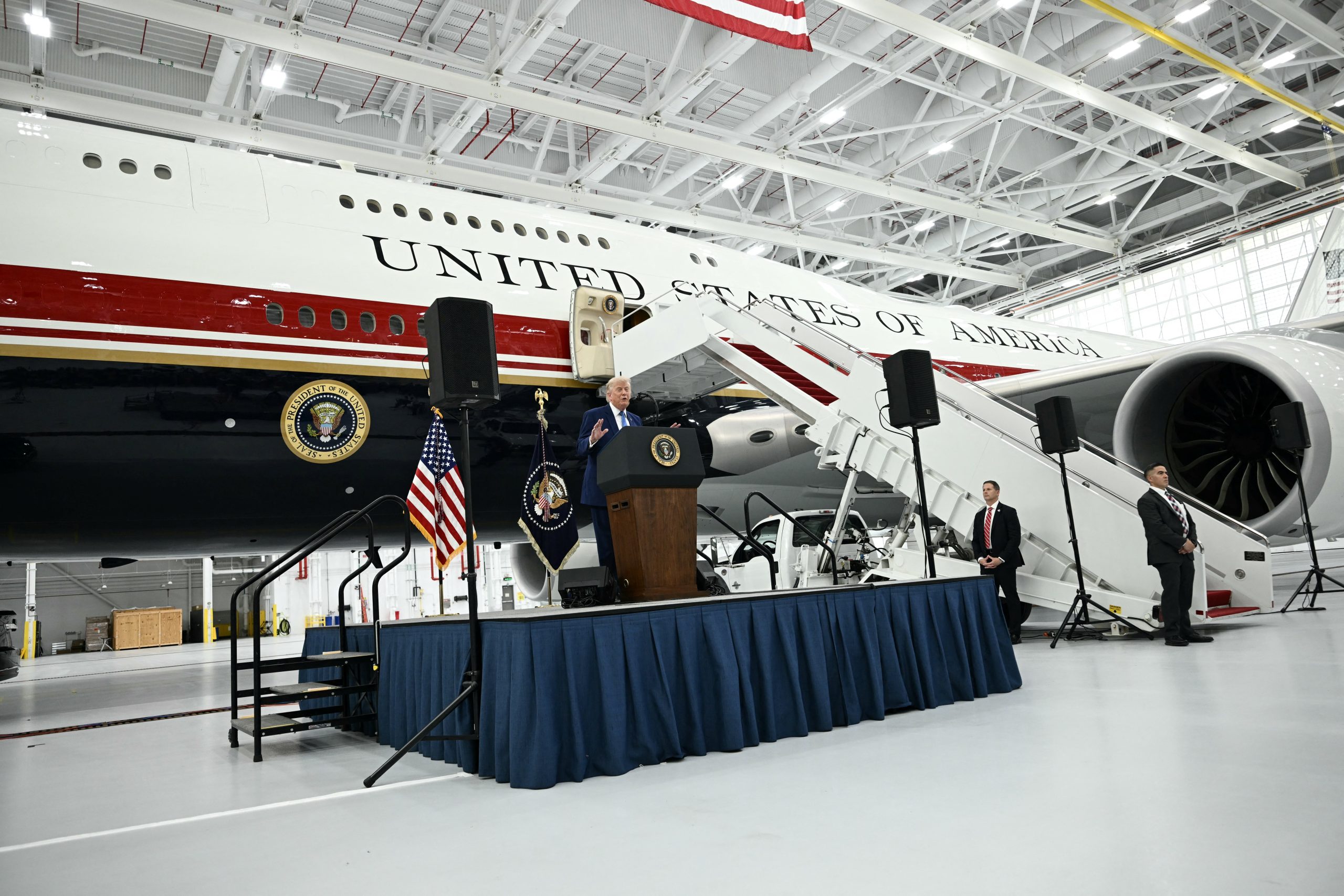 US President Donald Trump speaks in front of the new Air Force One, gifted to him by by Qatar, in a hangar at Joint Base Andrews in Maryland on June 19, 2026. White House officials bade farewell on June 18, 2026 to one of the two jets that have been used to transport US presidents for more than 30 years. The goodbye messages fueled speculation that a Boeing 747 controversially gifted to President Donald Trump by the Gulf emirate of Qatar is now due to enter service. Trump will be heading to Joint Base Andrews before spending the weekend at Camp David. (Photo by Brendan SMIALOWSKI / AFP via Getty Images)