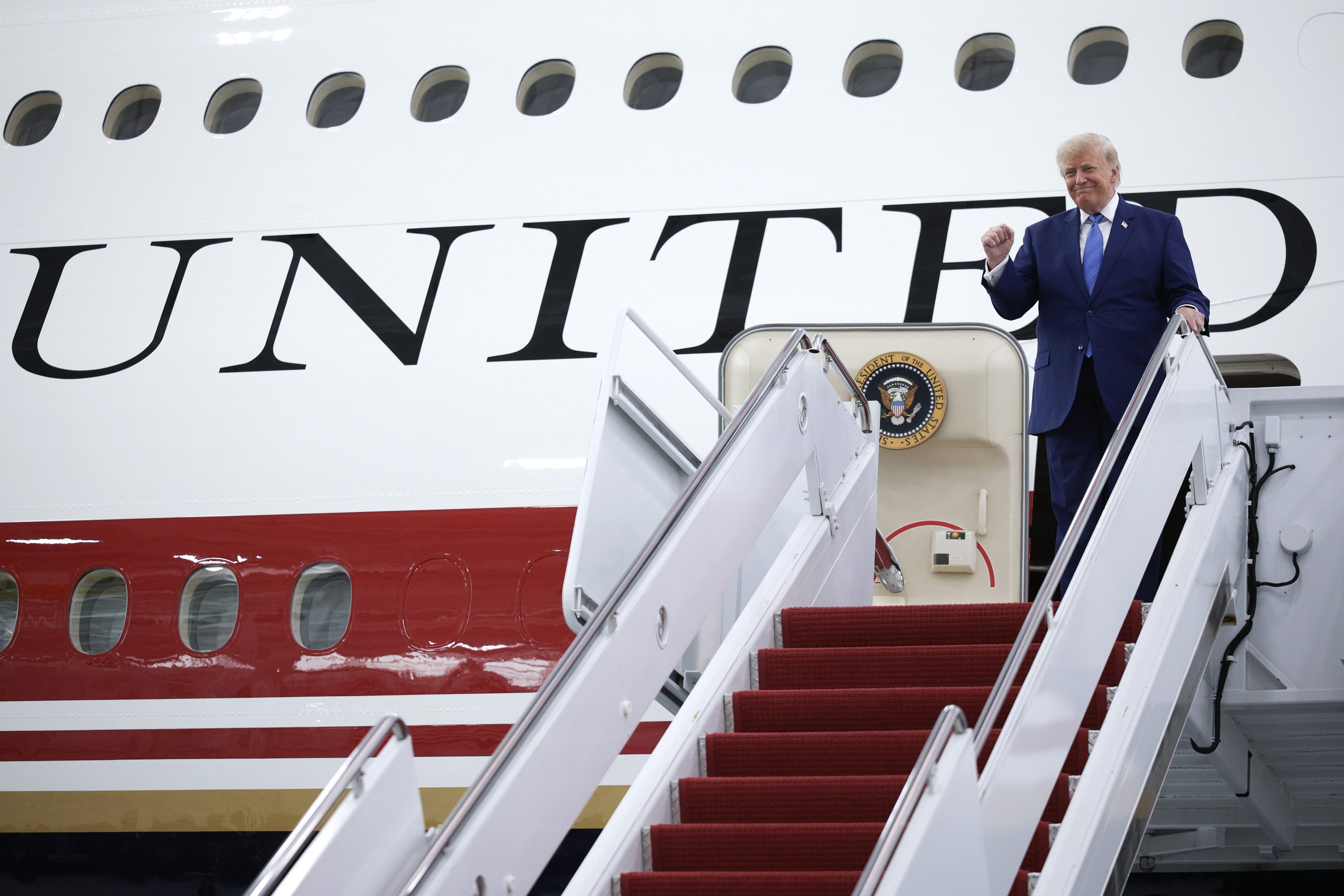 JOINT BASE ANDREWS, MARYLAND - JUNE 19: U.S. President Donald Trump pumps his fist after touring the inside of the newest aircraft in the presidential fleet at Andrews Air Force Base on June 19, 2026 at Joint Base Andrews, Maryland. The Qatari royal family gifted the lavish $400 million, 13-year-old Boeing 747-8 to the U.S. Air Force to be used as the new Air Force One. (Photo by Alex Wong/Getty Images)