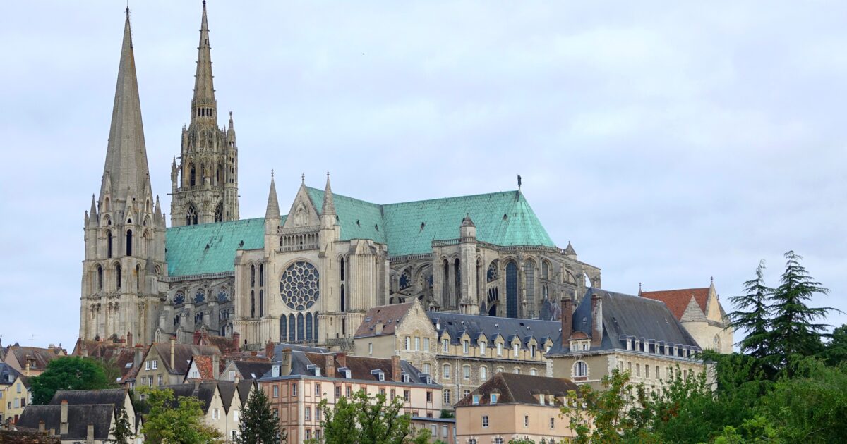 Chartres Cathedral towers over the historic town of Chartres, France, showcasing its stunning Gothic architecture and intricate stained glass windows.