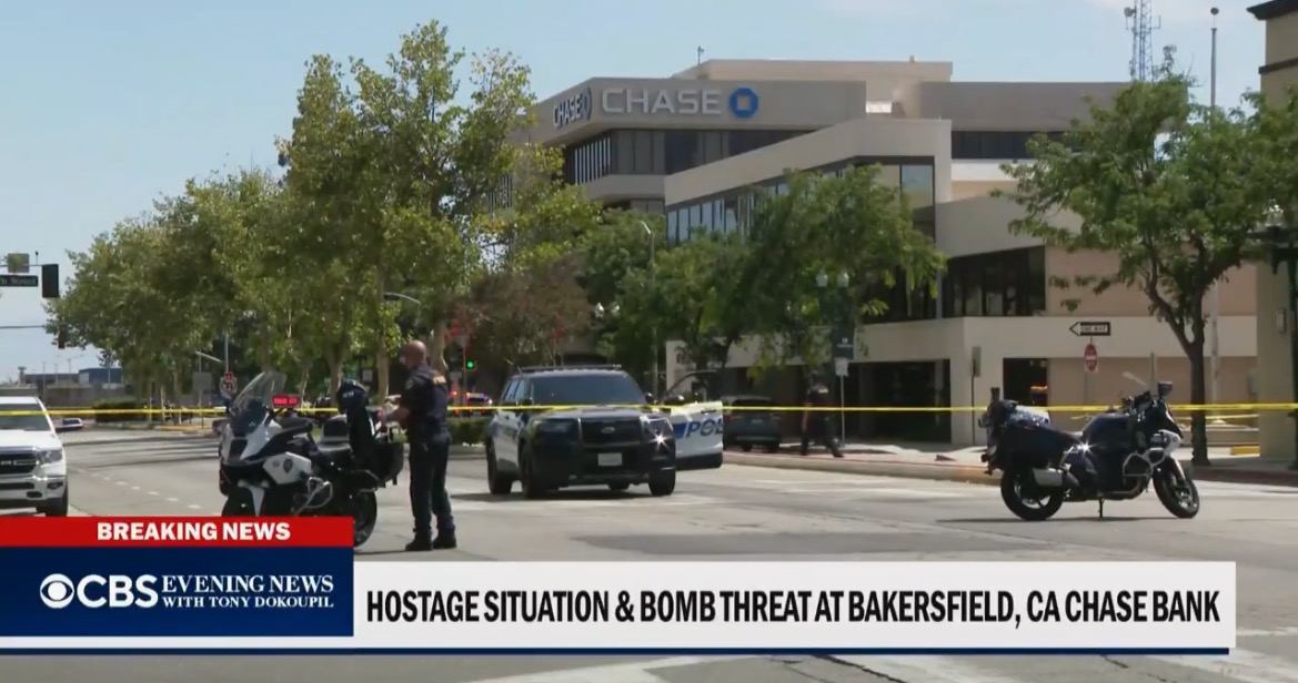 Police respond to a hostage situation and bomb threat at a Chase Bank in Bakersfield, California, with emergency vehicles and caution tape visible.