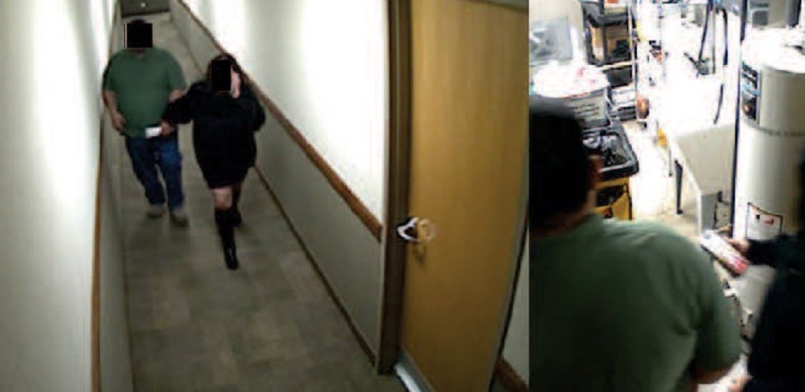 Surveillance image showing two individuals walking down a hallway, with one entering a utility room.