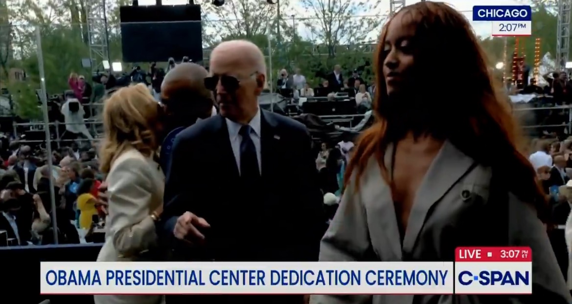 President Joe Biden attends the dedication ceremony for the Obama Presidential Center in Chicago, surrounded by a large crowd and media presence.