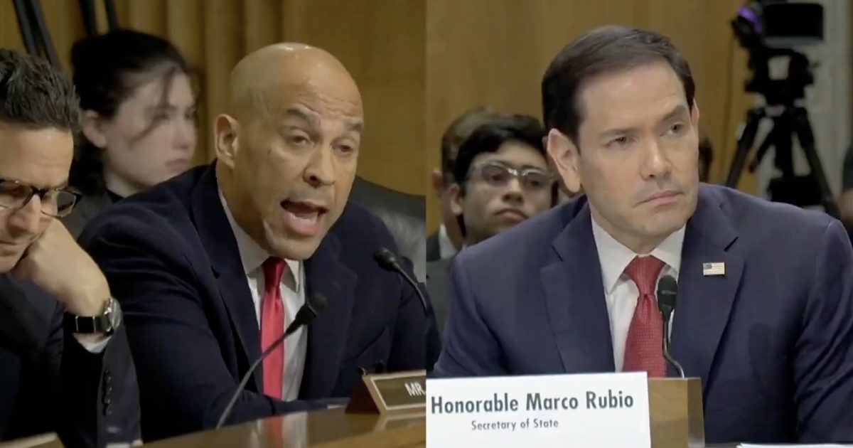 U.S. Senate hearing featuring Senator Cory Booker speaking passionately while Senator Marco Rubio listens attentively, with audience members in the background.