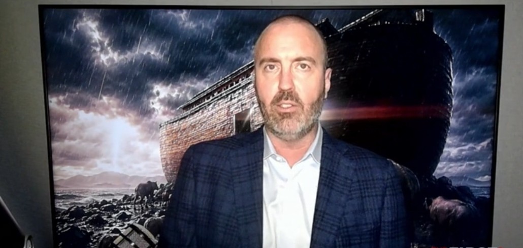 Man in a suit stands in front of a stormy backdrop featuring a large ark, highlighting themes of resilience and survival.